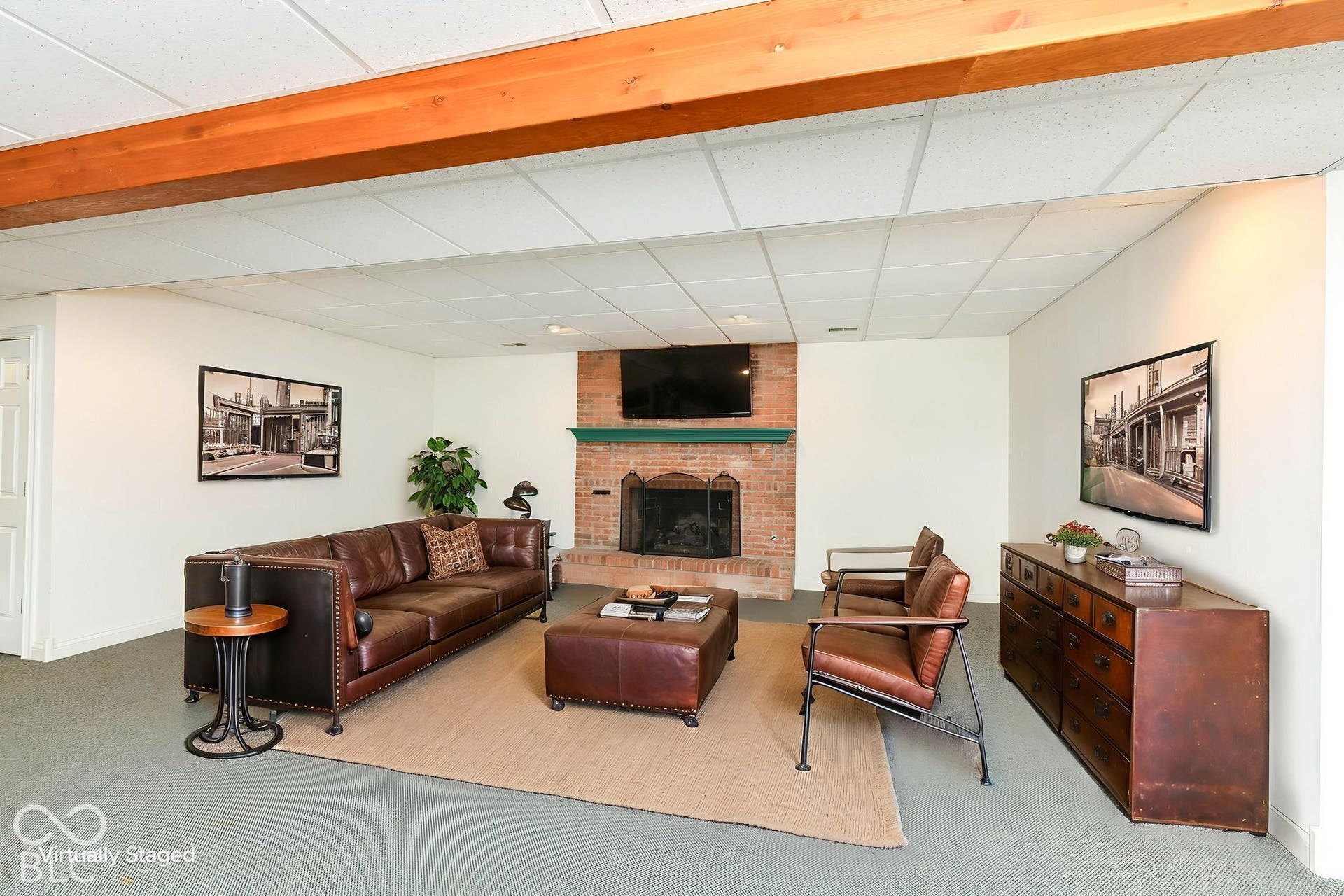 6431 Shamel Drive, Indianapolis, IN 46278 Virtually Altered - Basement Rec Room. Exposed wood ceiling beam, brick fireplace with a green mantel, recessed lighting, and a drop ceiling
