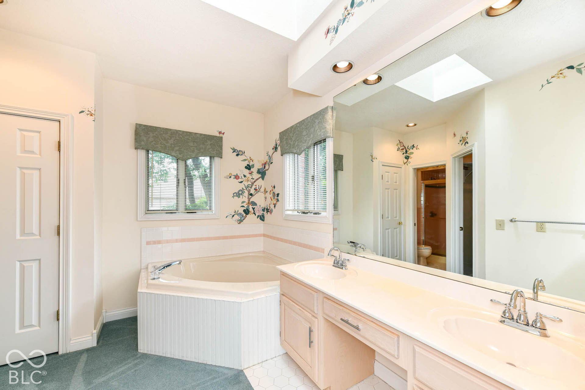 6431 Shamel Drive, Indianapolis, IN 46278 Primary Bathroom. Dual vanity with integrated sinks, built-in bathtub with tile surround, skylight, and recessed lighting
