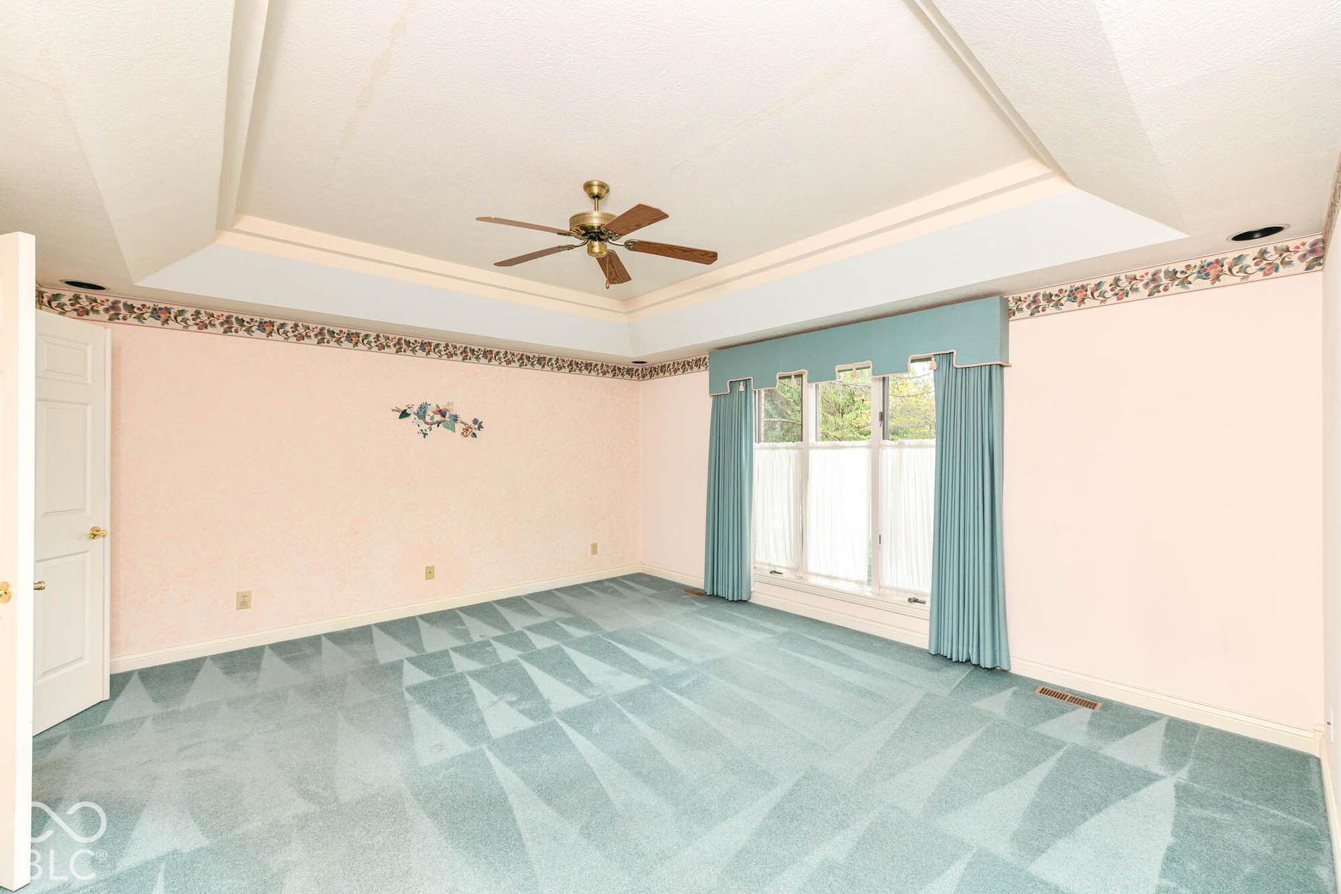 6431 Shamel Drive, Indianapolis, IN 46278 Main floor Primary Bedroom. Tray ceiling with a ceiling fan, wall-to-wall carpeting, and a multi-pane window with valance