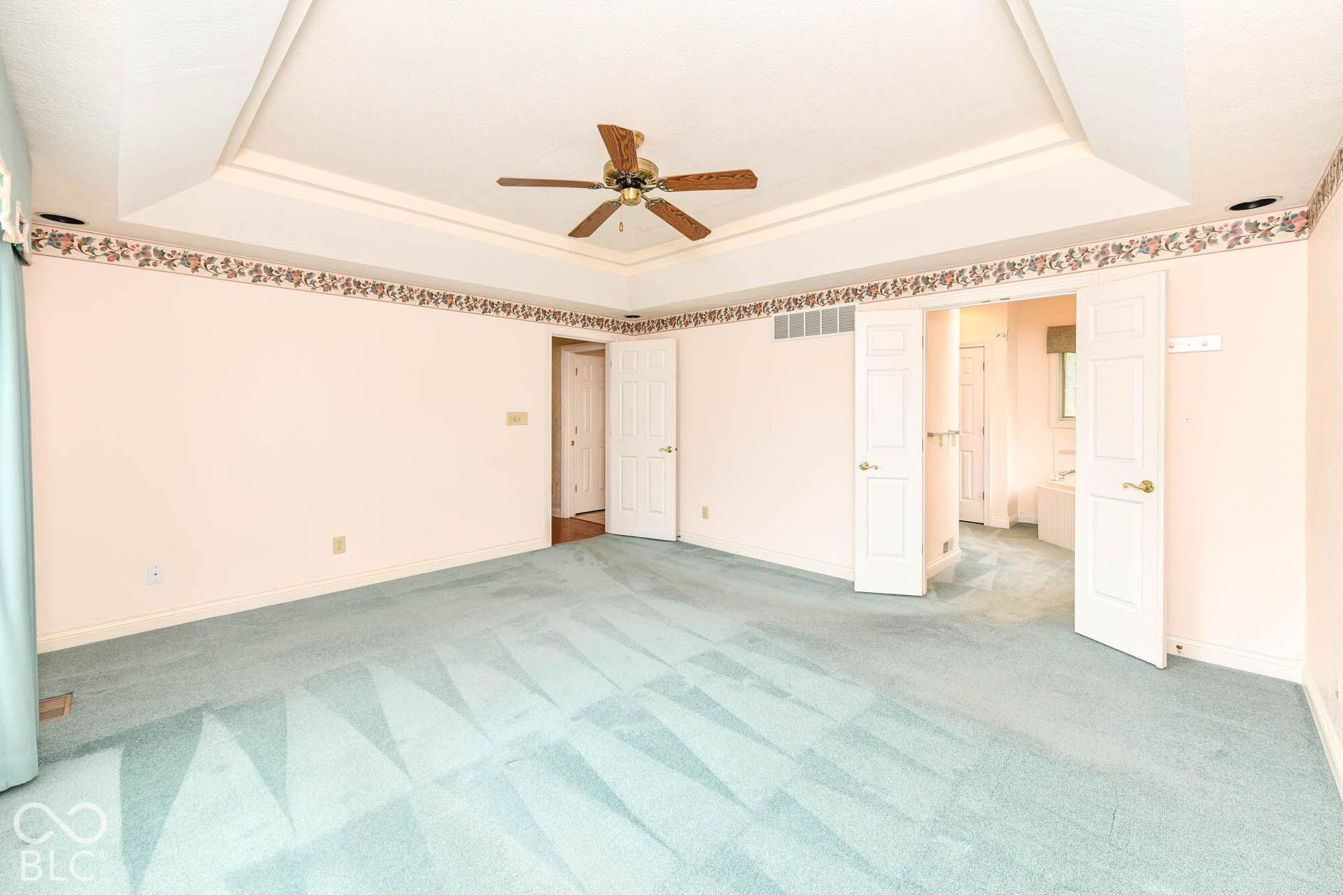 6431 Shamel Drive, Indianapolis, IN 46278 Main floor Primary Bedroom. Tray ceiling with a ceiling fan, wall-to-wall carpeting