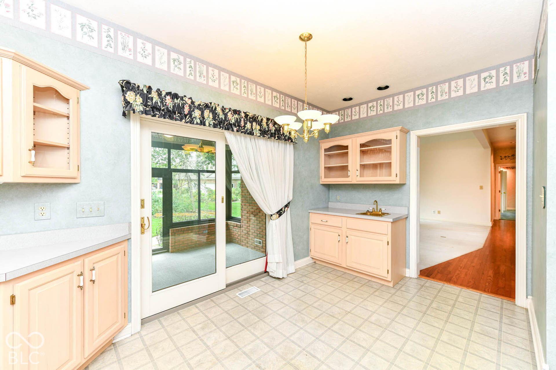 6431 Shamel Drive, Indianapolis, IN 46278 Breakfast area with light-toned cabinetry, built-in wet bar, and a gold-toned chandelier