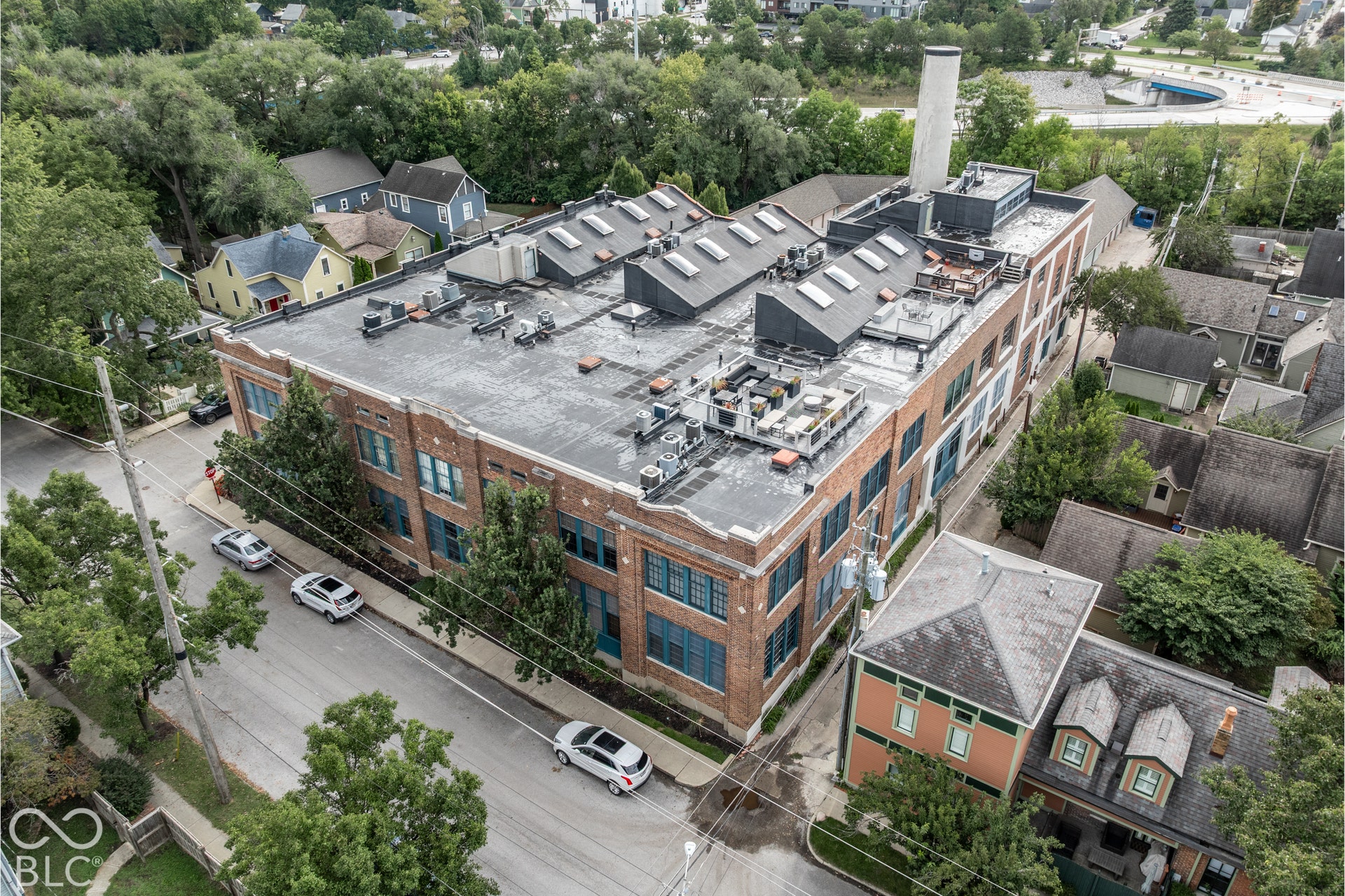 Brick multi-story building with multiple skylights and industrial rooftop features