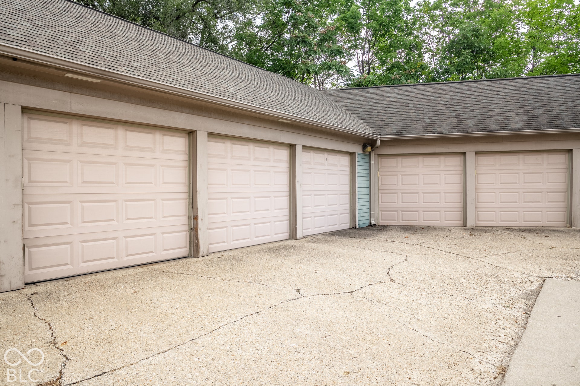 Attached multi-bay garage with five individual garage doors