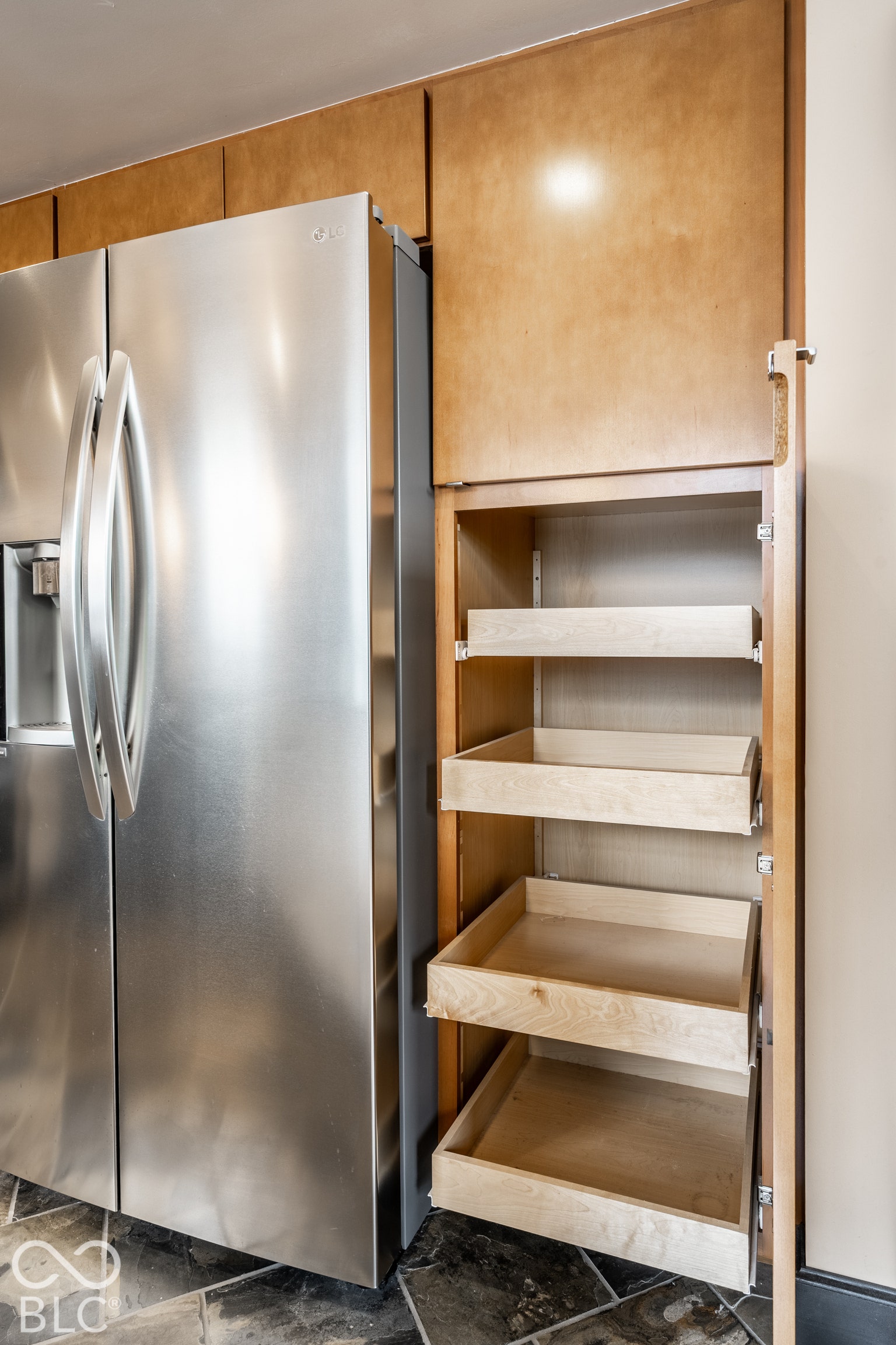 Stainless steel refrigerator with a French door design and integrated ice/water dispenser