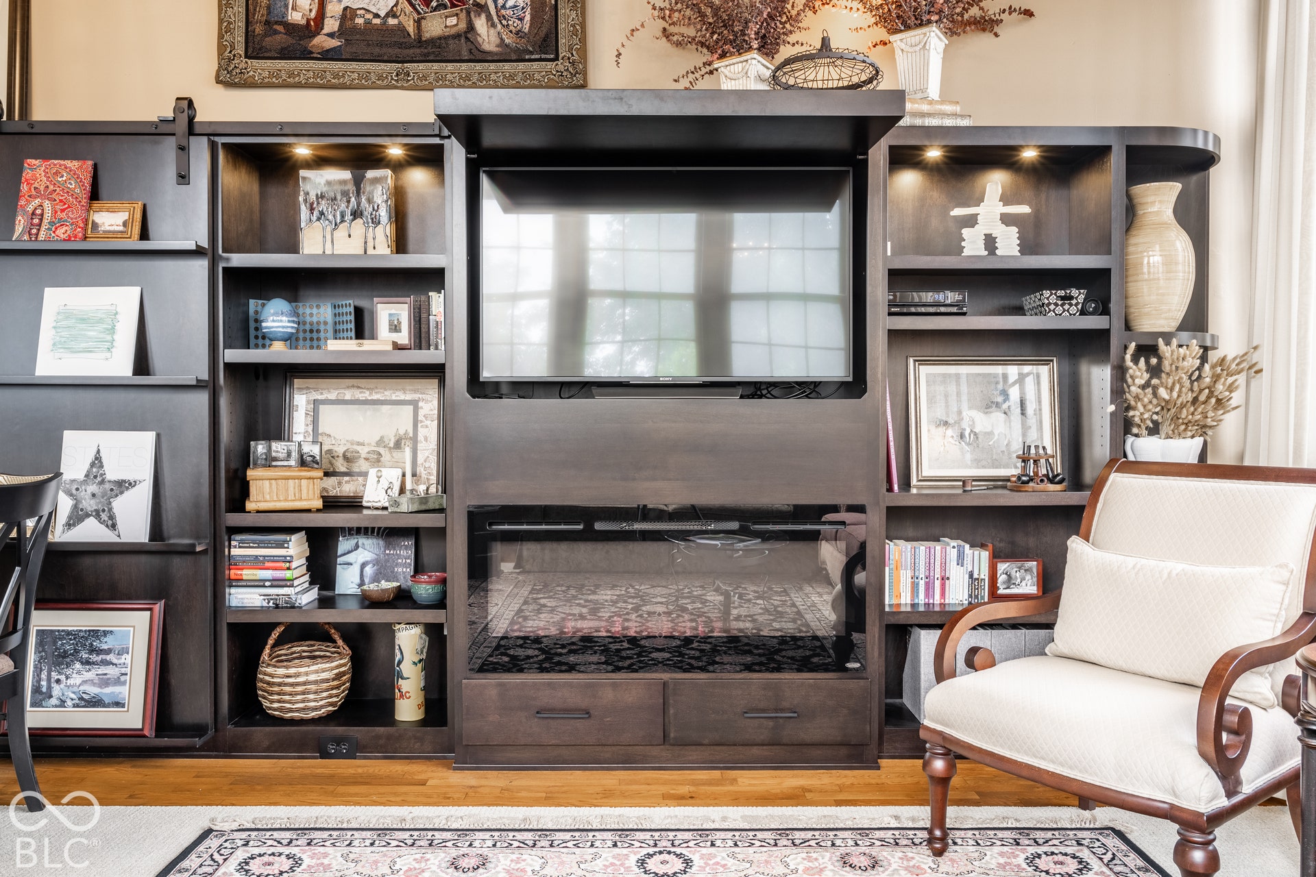 Built-in media center with integrated shelving and recessed lighting