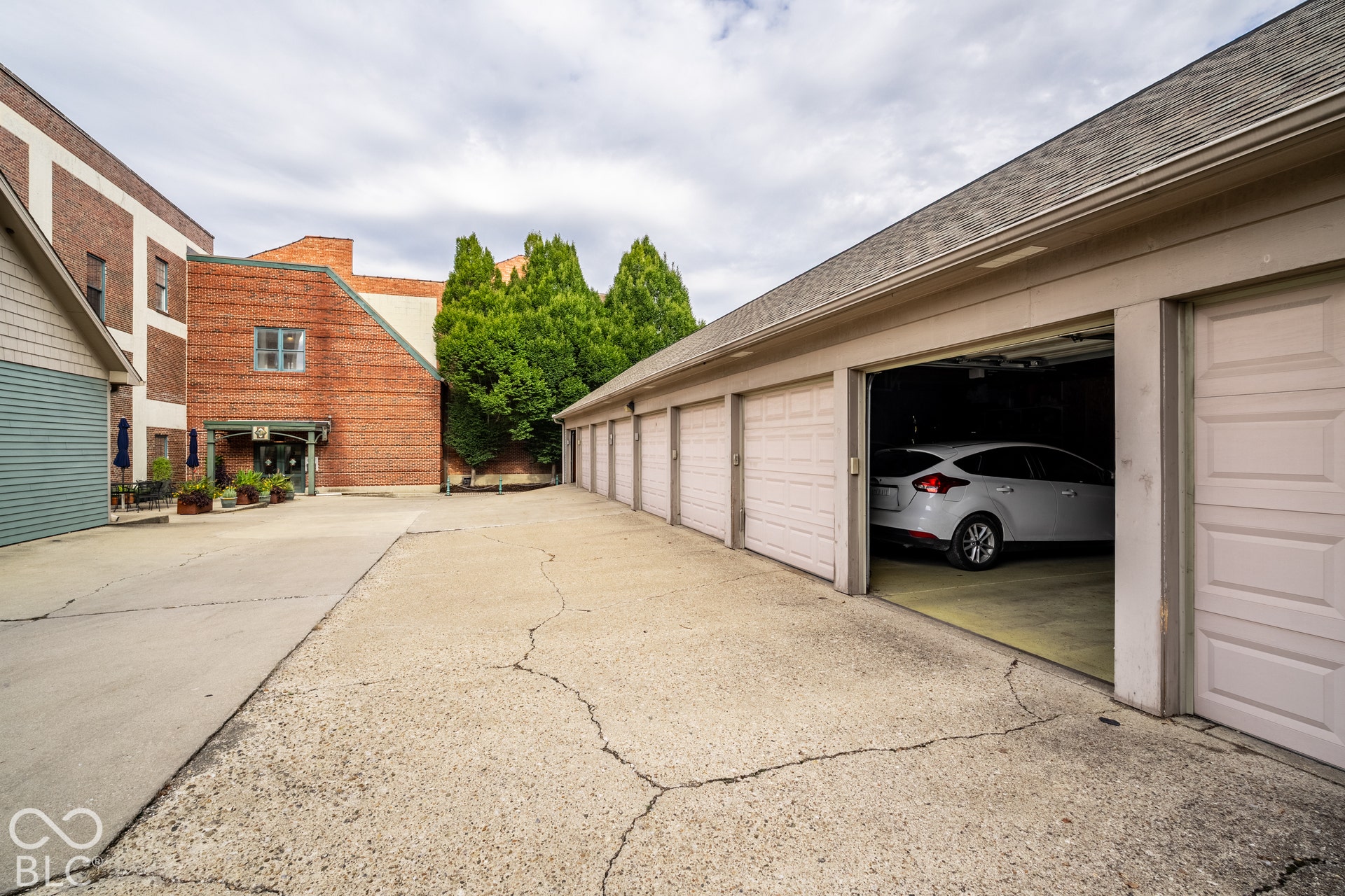 Attached single-car garage featuring a paneled door, offering convenient parking