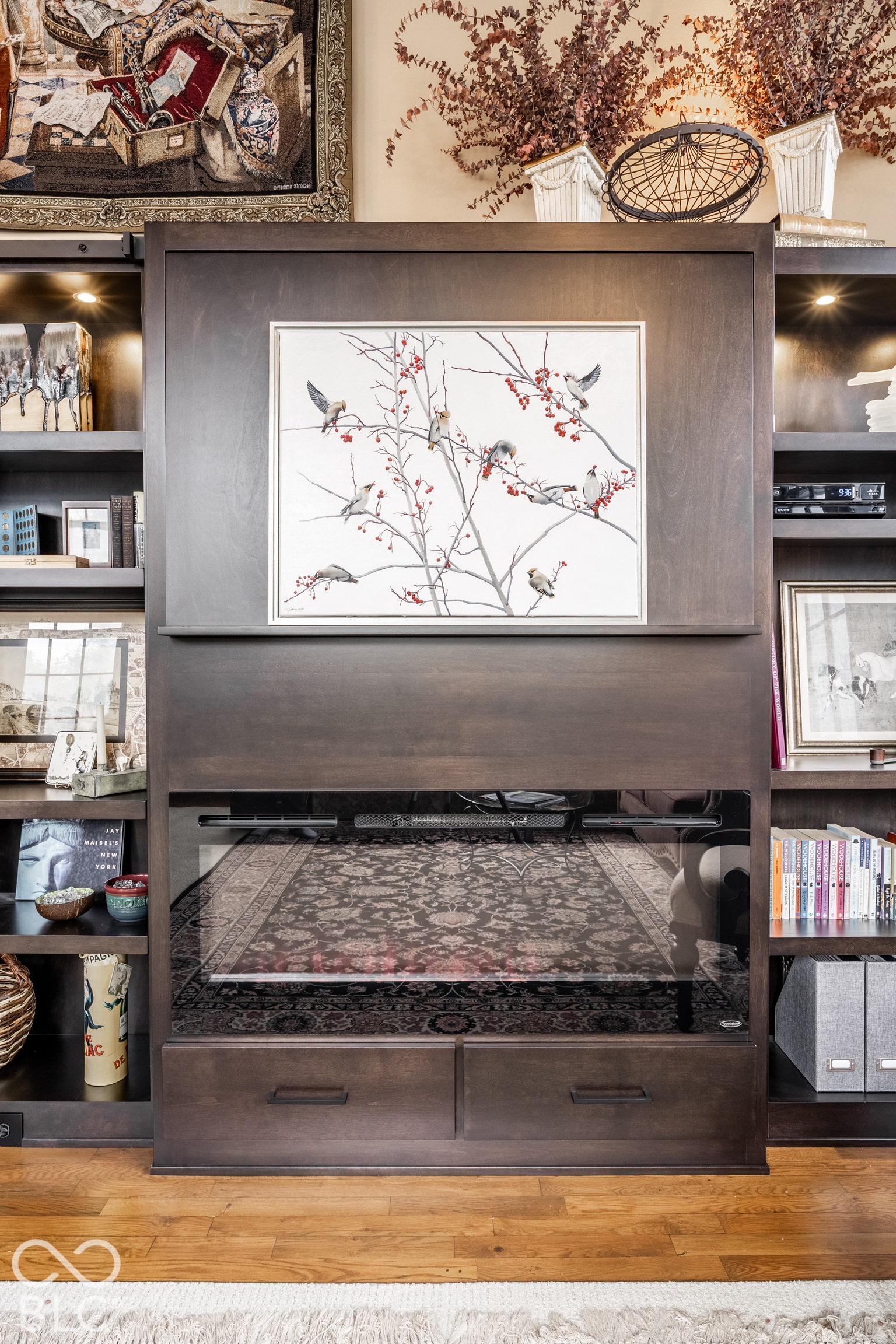 Built-in shelving unit with recessed lighting, dark wood-finish cabinetry, and integrated storage drawers