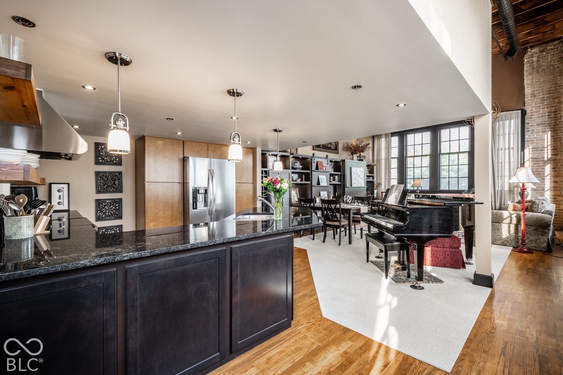 Kitchen island with dark wood-finish cabinetry and dark stone countertop
