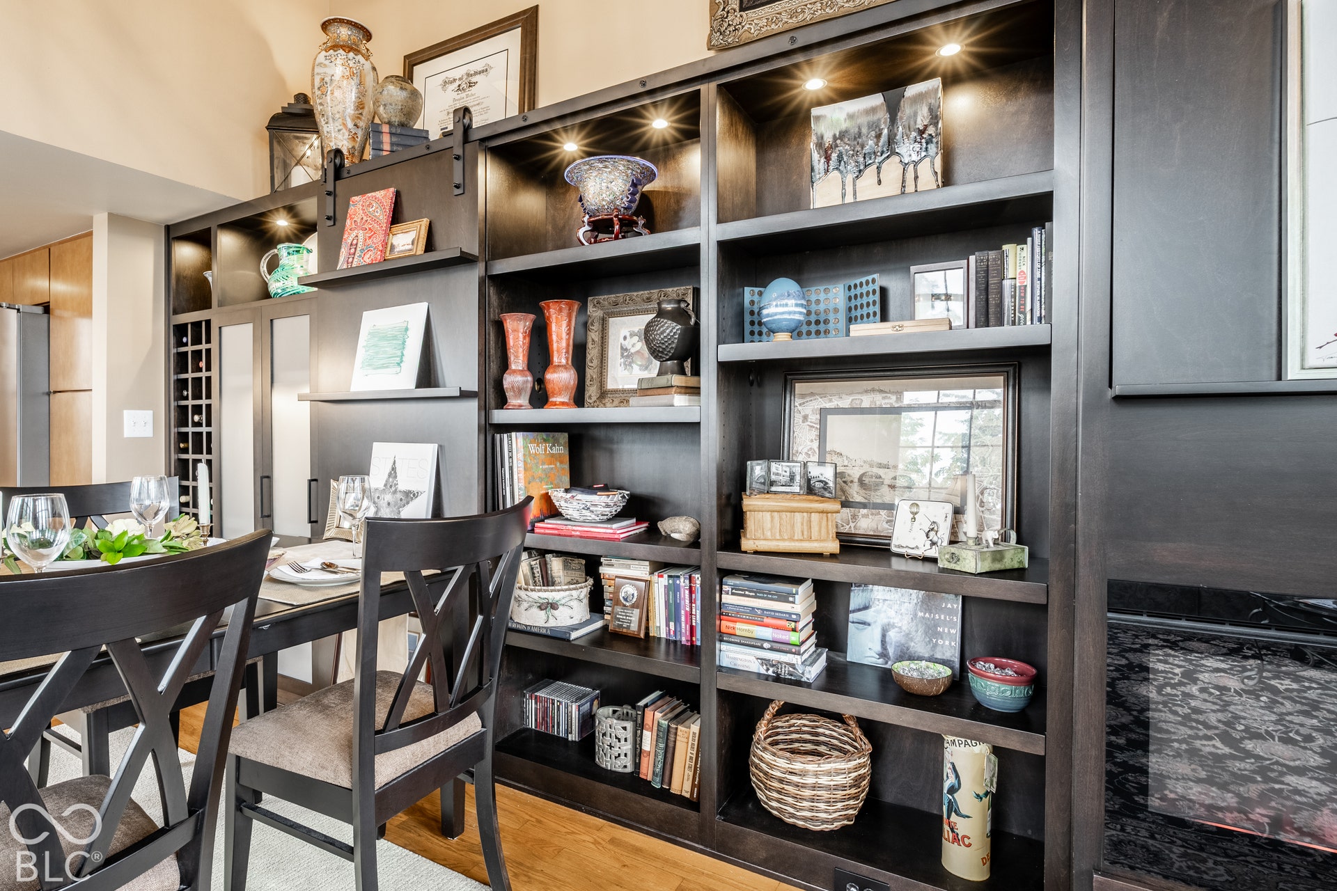 Built-in shelving with integrated lighting, a dedicated wine rack, and rich wood-finish construction