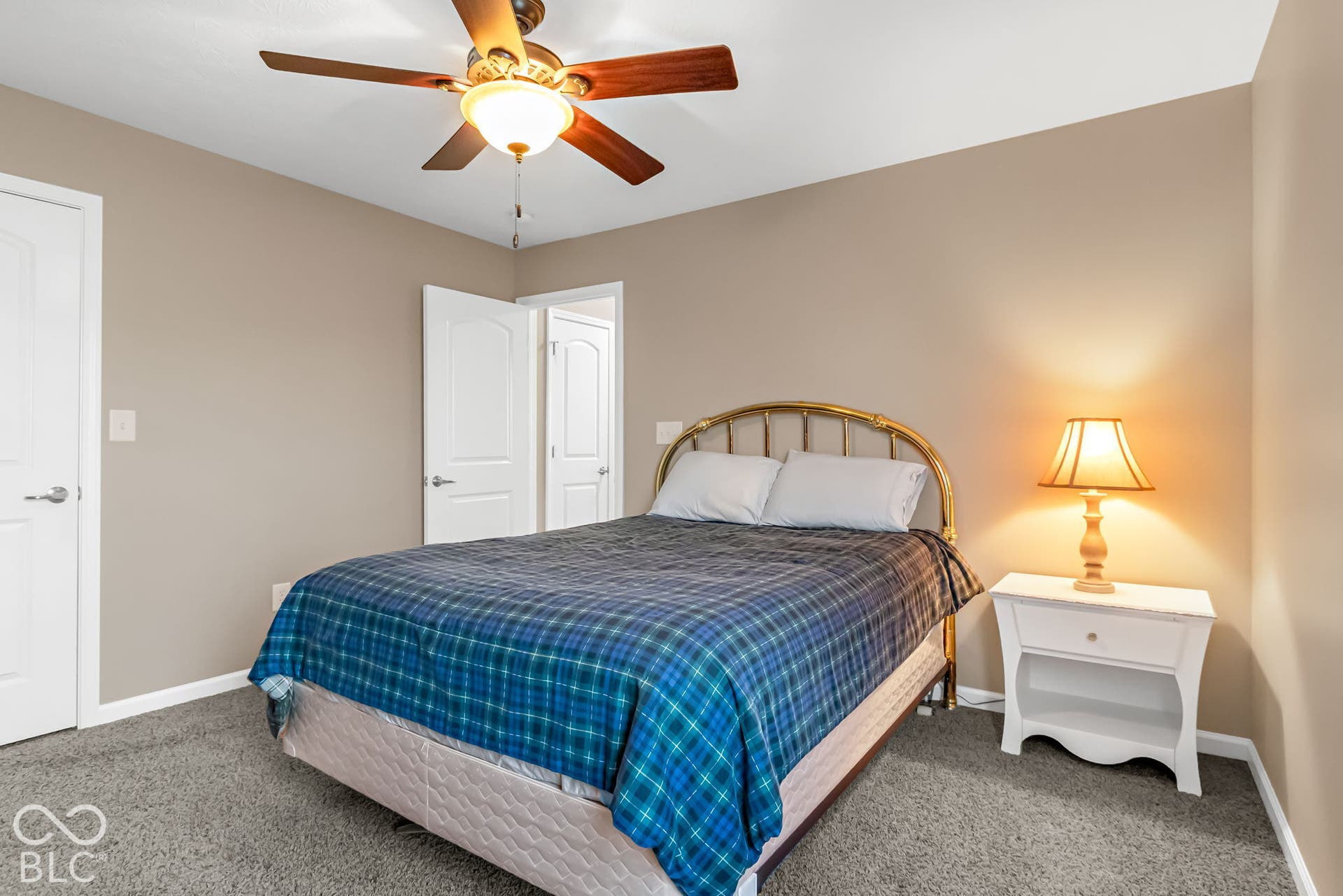 Neutral-toned walls complement plush carpeting