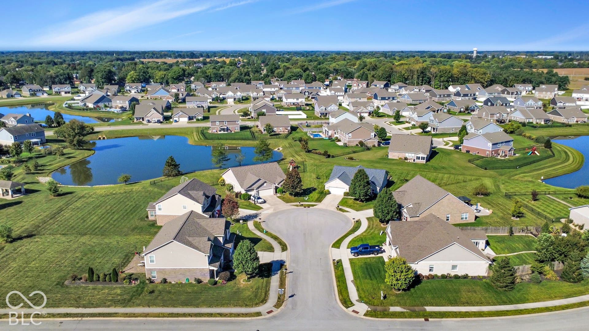 Residential neighborhood featuring a cul-de-sac, multiple single-family homes, landscaped yards, and two ponds