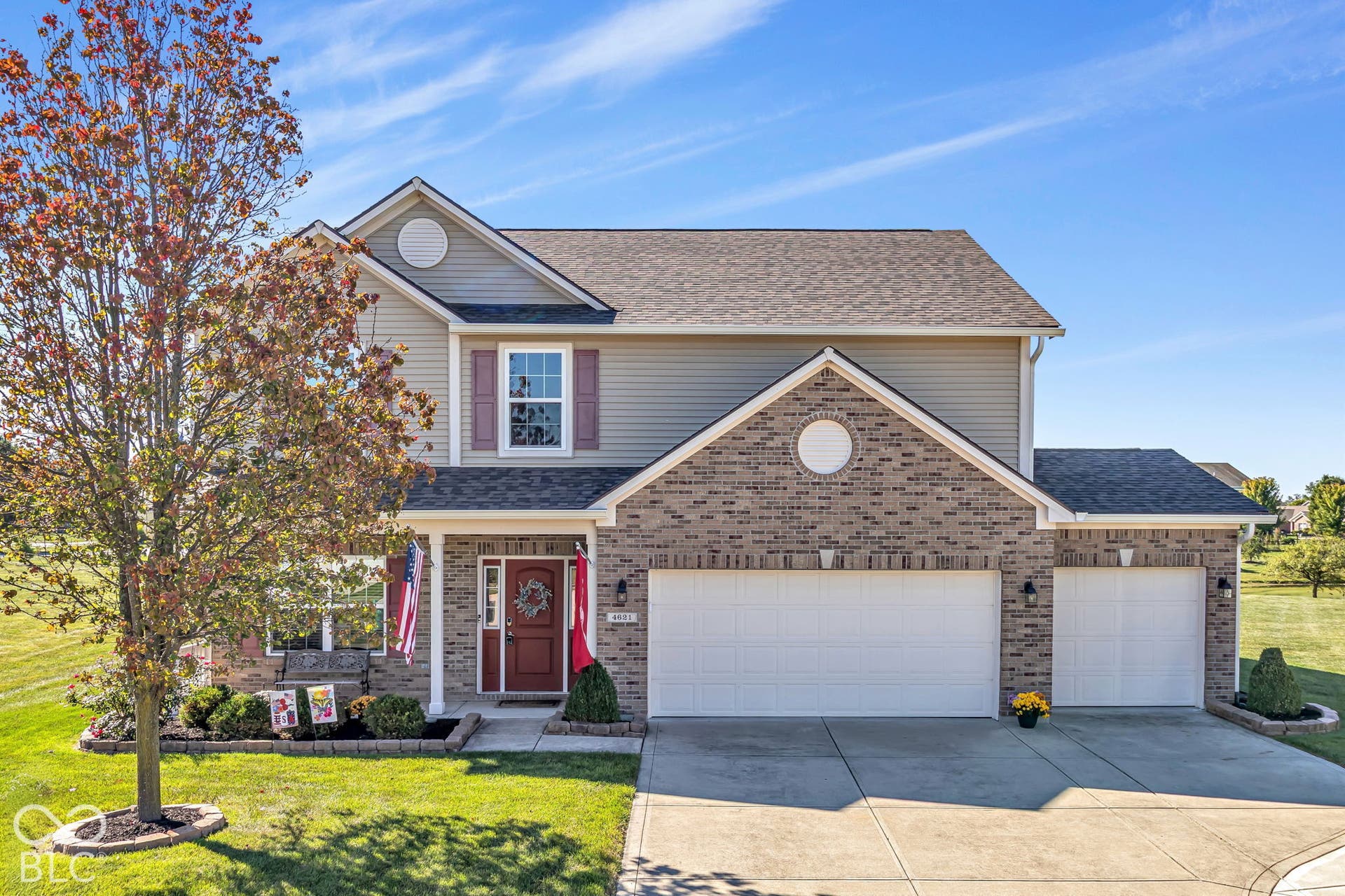 Brick and siding exterior with a gabled roofline