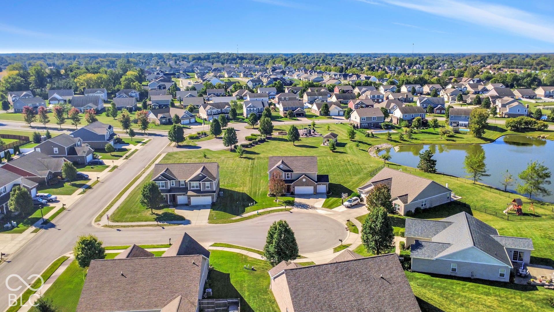 Residential neighborhood with mature landscaping and water feature