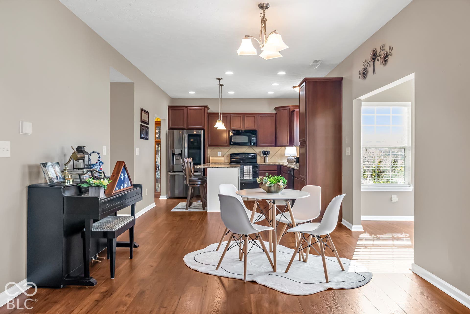 Wood-finish flooring throughout, with recessed lighting and a chandelier fixture