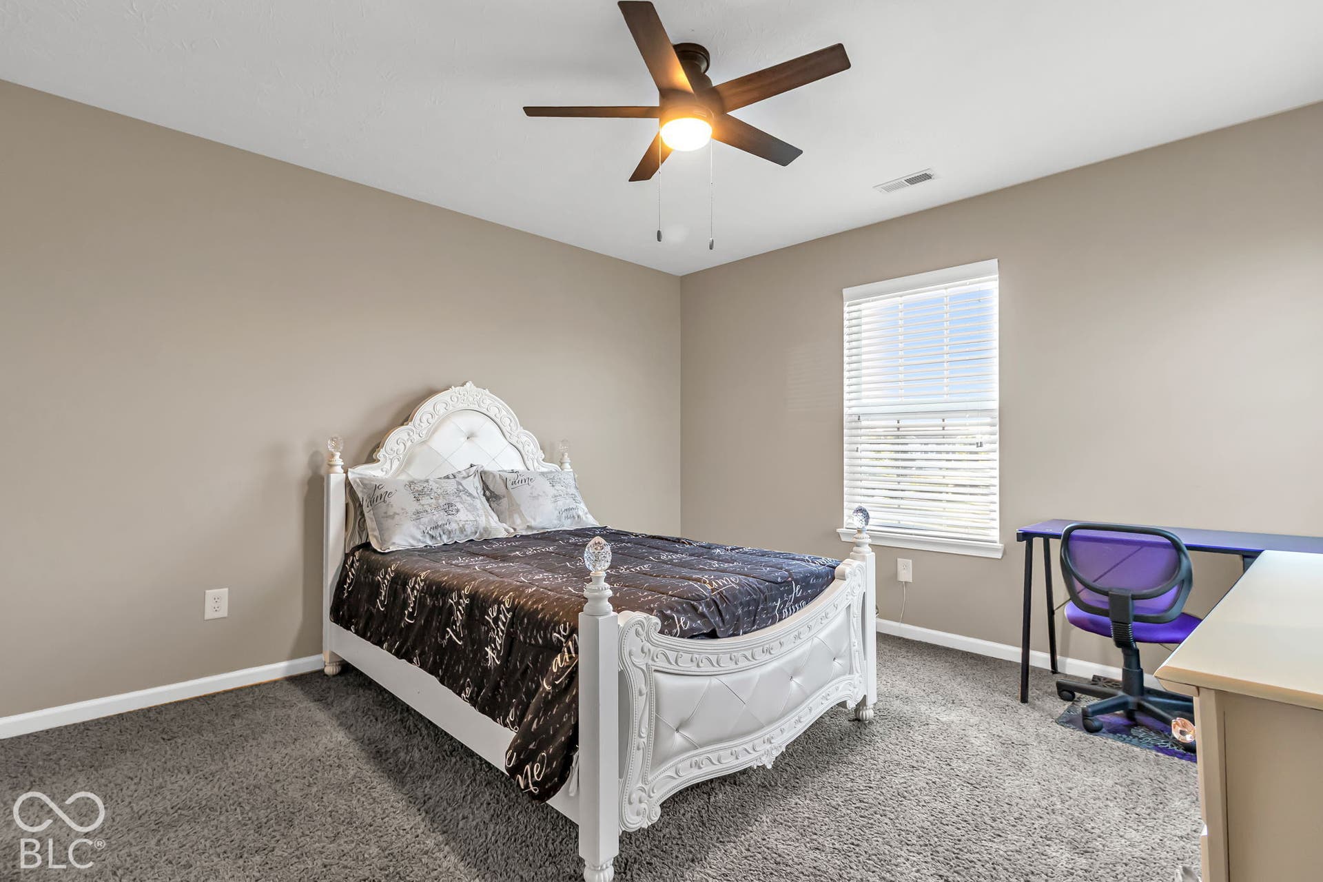 Neutral-toned walls complement the gray carpeting