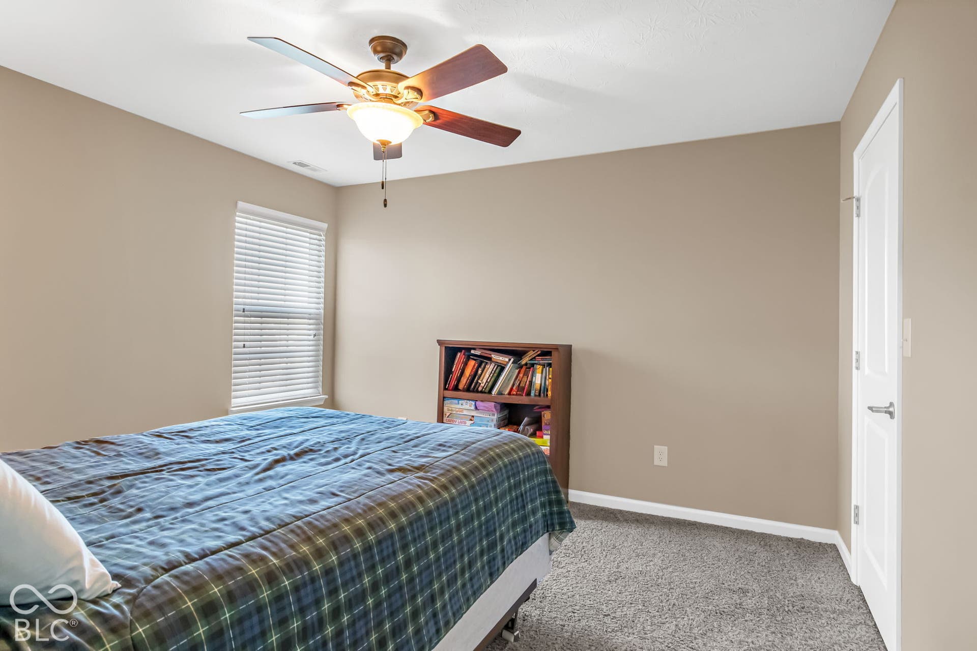 Neutral-toned walls complement the gray carpeting