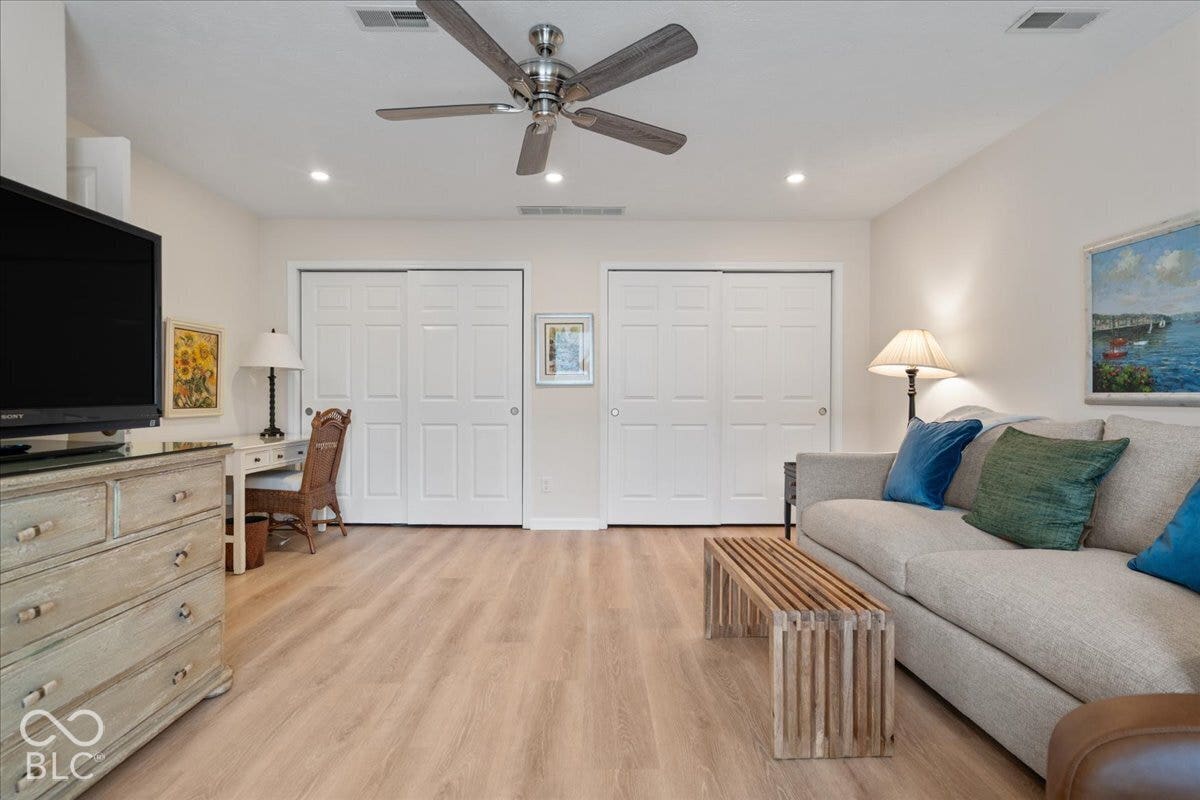 Currently used as Family Room featuring wood-finish flooring, recessed lighting, dual sliding-panel closets, and a brushed nickel ceiling fan