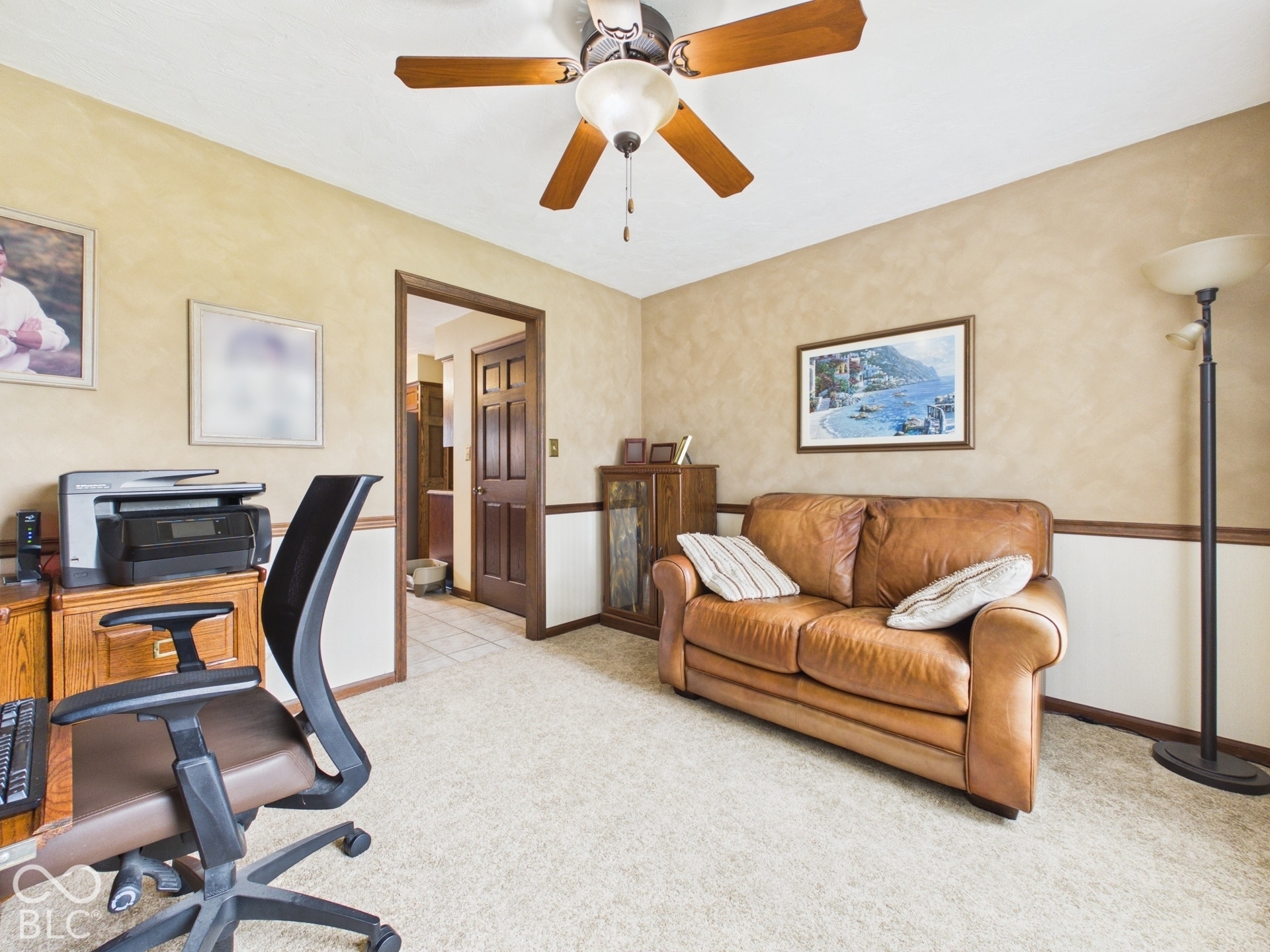 Recessed door, wood-finish paneling, and ceiling fan with integrated lighting