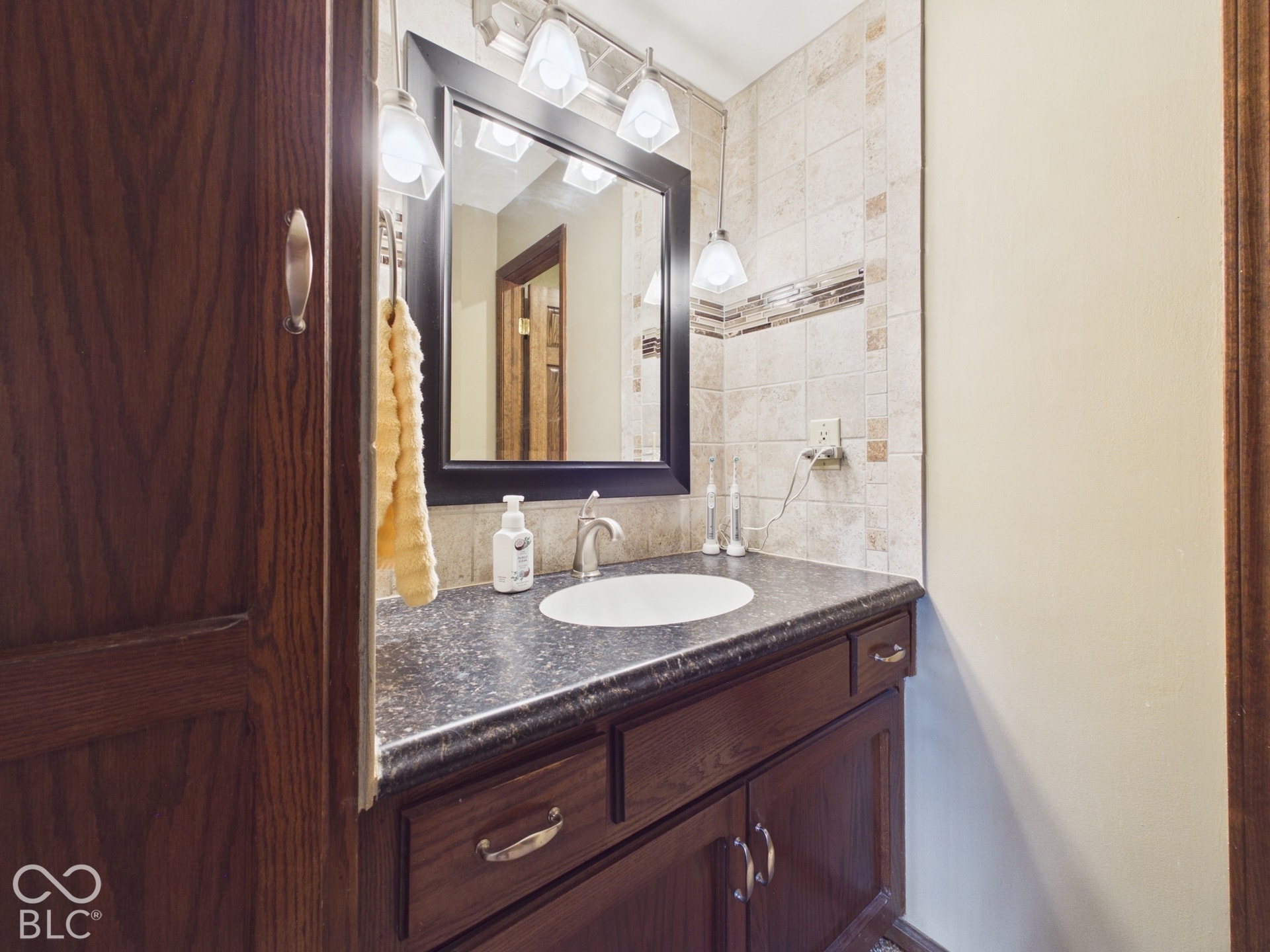 Dark wood-finish vanity with a built-in sink and countertop