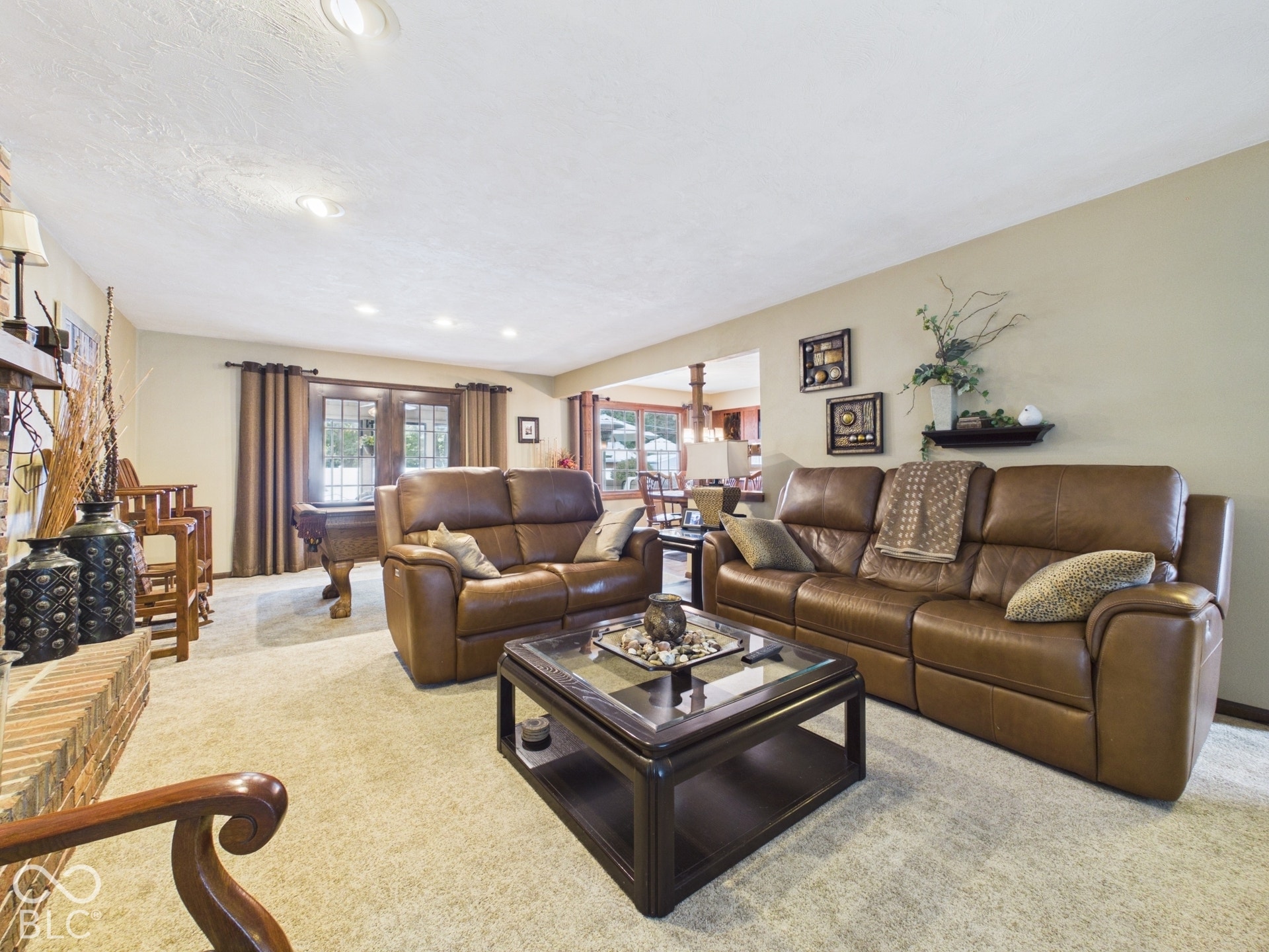 Recessed ceiling lighting, brick fireplace, and light-toned wall finishes