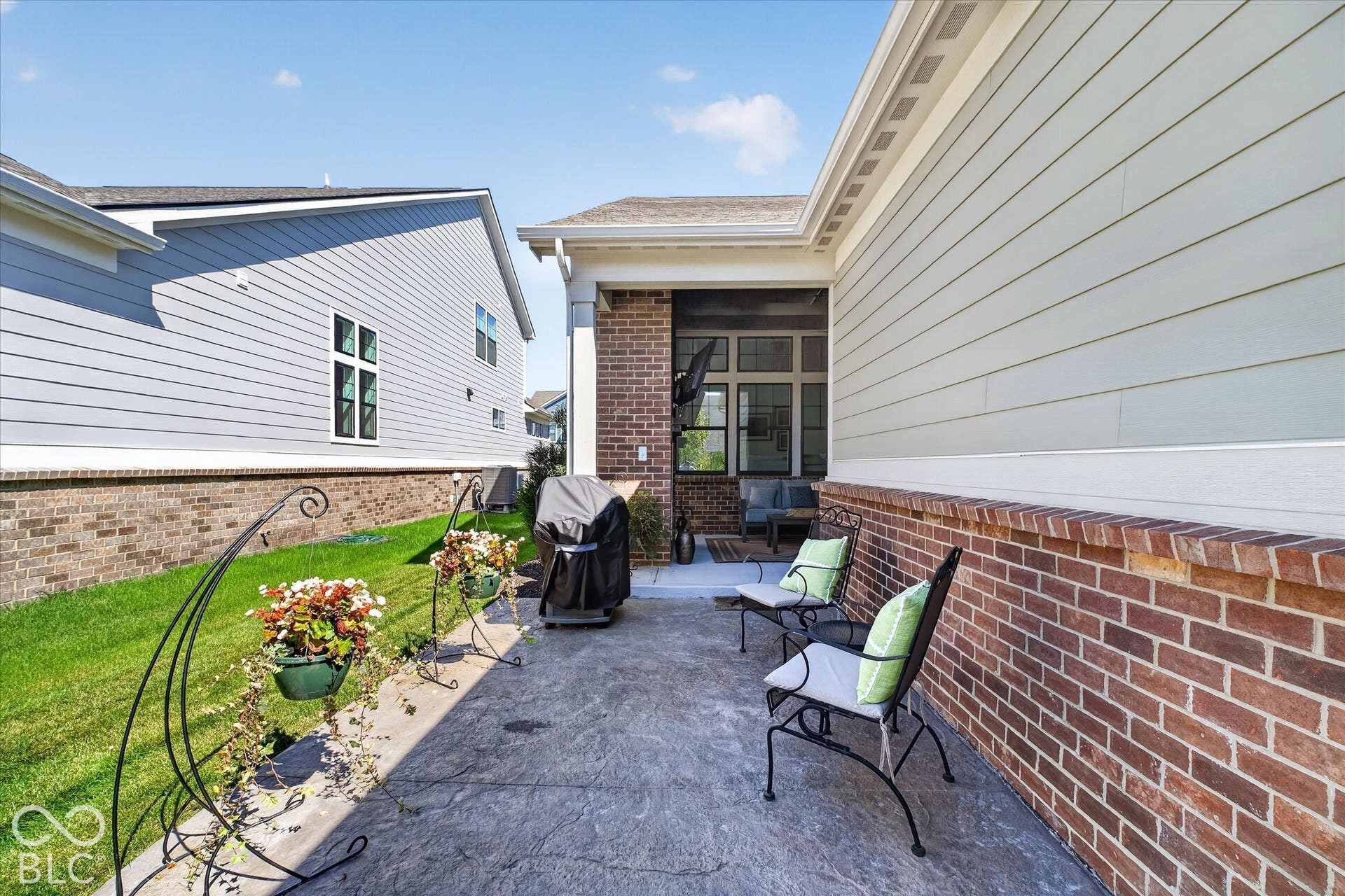 1405 Lake Haven Lane, Westfield, IN 46074 Stamped concrete patio featuring a brick and siding exterior, with an adjacent covered screened porch