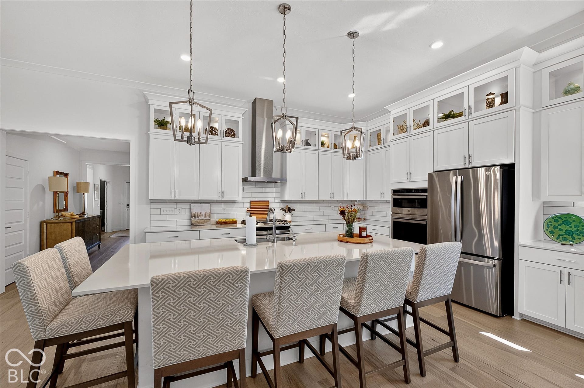 1405 Lake Haven Lane, Westfield, IN 46074 Expansive kitchen island, white shaker-style cabinetry, stainless steel appliances, subway tile backsplash, and light wood-finish flooring
