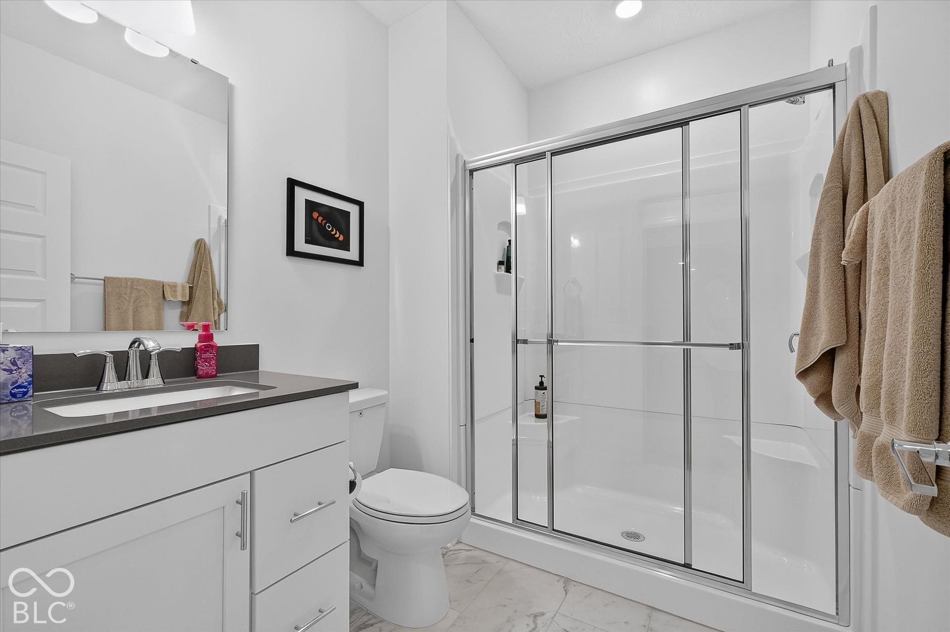 1405 Lake Haven Lane, Westfield, IN 46074 White vanity with a dark countertop, undermount sink, chrome faucet, and mirrored medicine cabinet