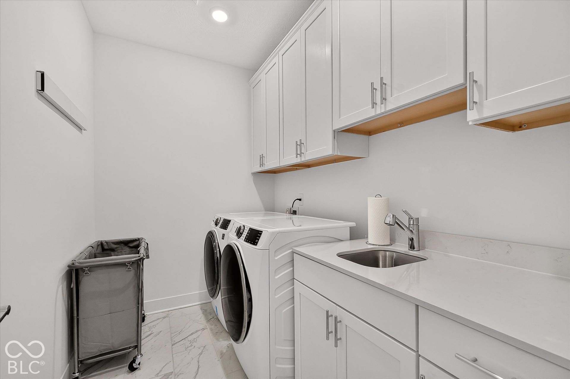 1405 Lake Haven Lane, Westfield, IN 46074 White shaker-style cabinetry, light-toned countertop, integrated sink with chrome faucet, recessed lighting, and tile flooring