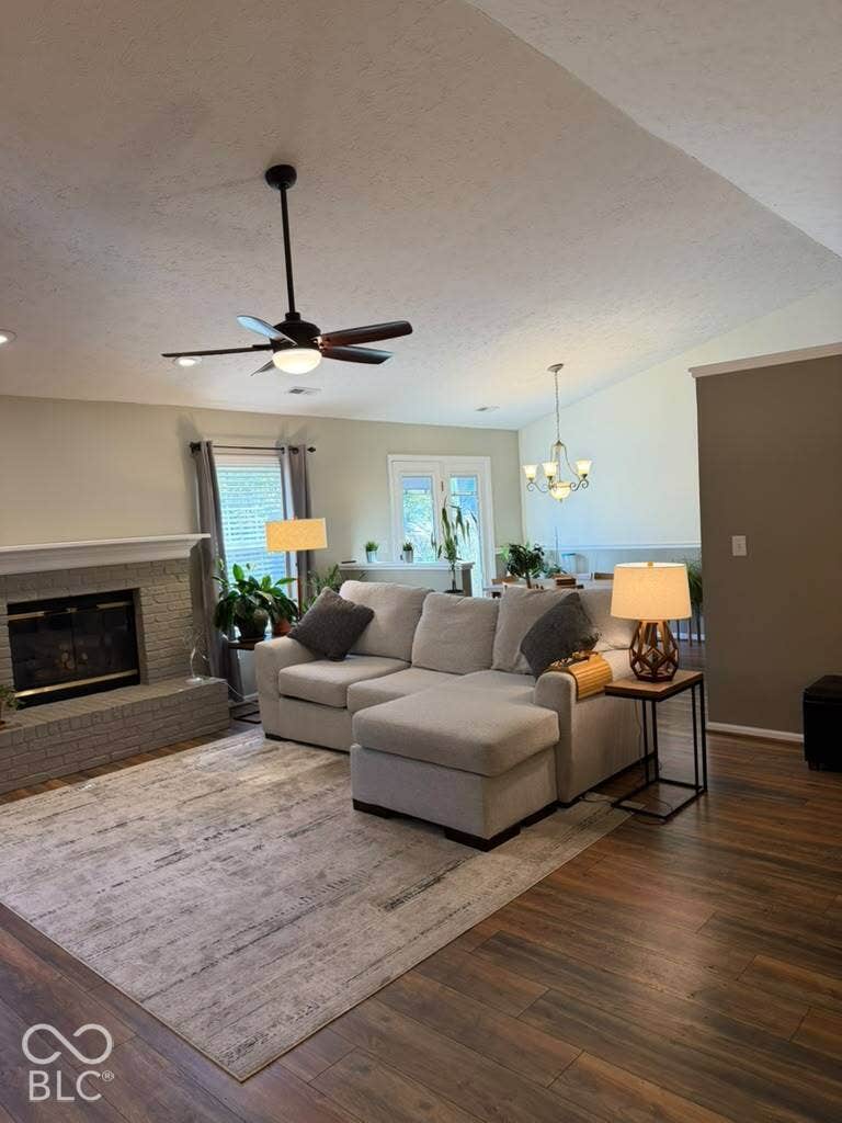 Vaulted ceiling, ceiling fan, wood-finish flooring, brick fireplace, French doors