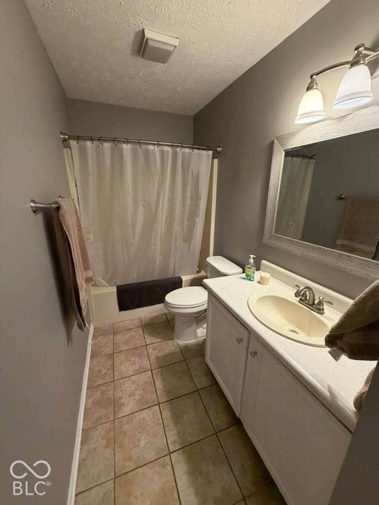Full bathroom featuring a single vanity, integrated sink, and white cabinetry