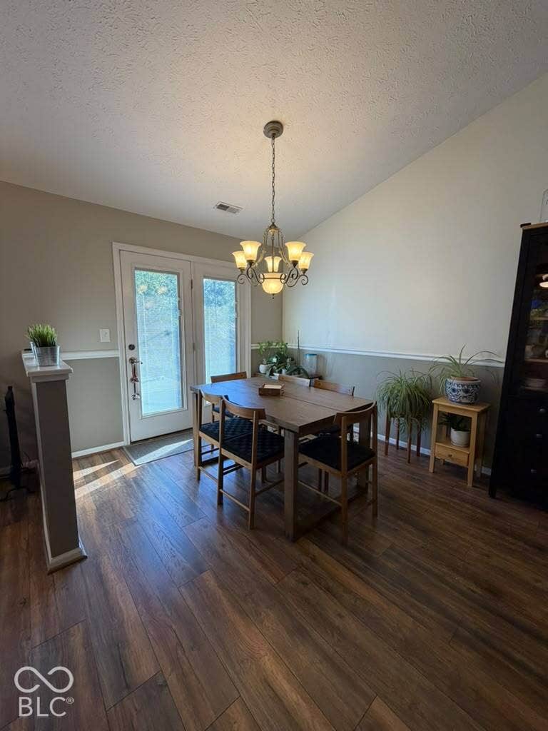 Wood-finish flooring, vaulted ceiling, and dual French patio doors
