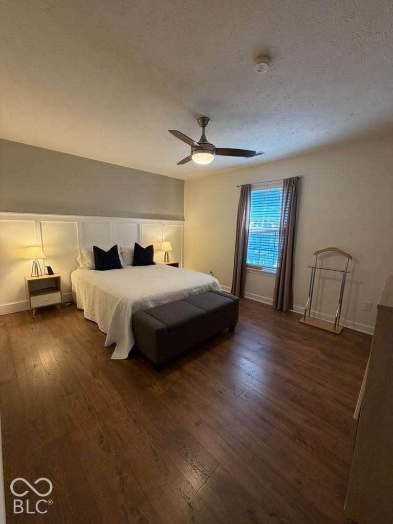 Wood-finish flooring throughout, complemented by a ceiling fan with integrated lighting