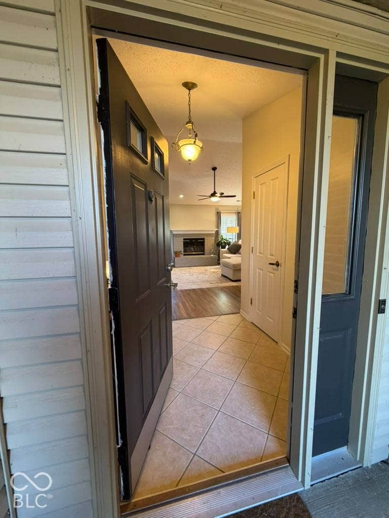 Entryway featuring diagonal tile flooring and a hanging pendant light
