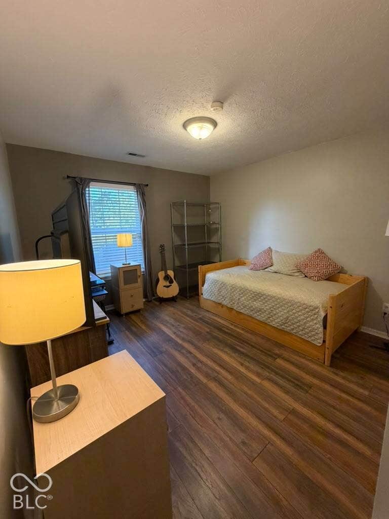 Wood-finish flooring throughout the room