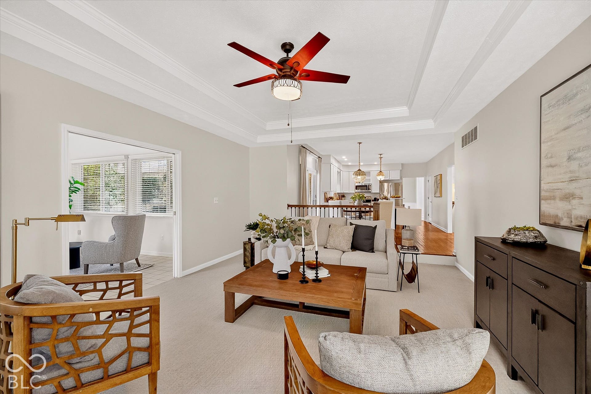 Tray ceiling with crown molding, recessed lighting, and a ceiling fan
