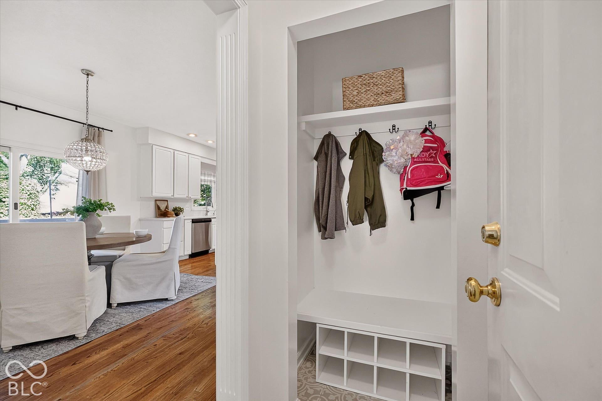 Entryway featuring a built-in bench, storage cubbies, and wall hooks