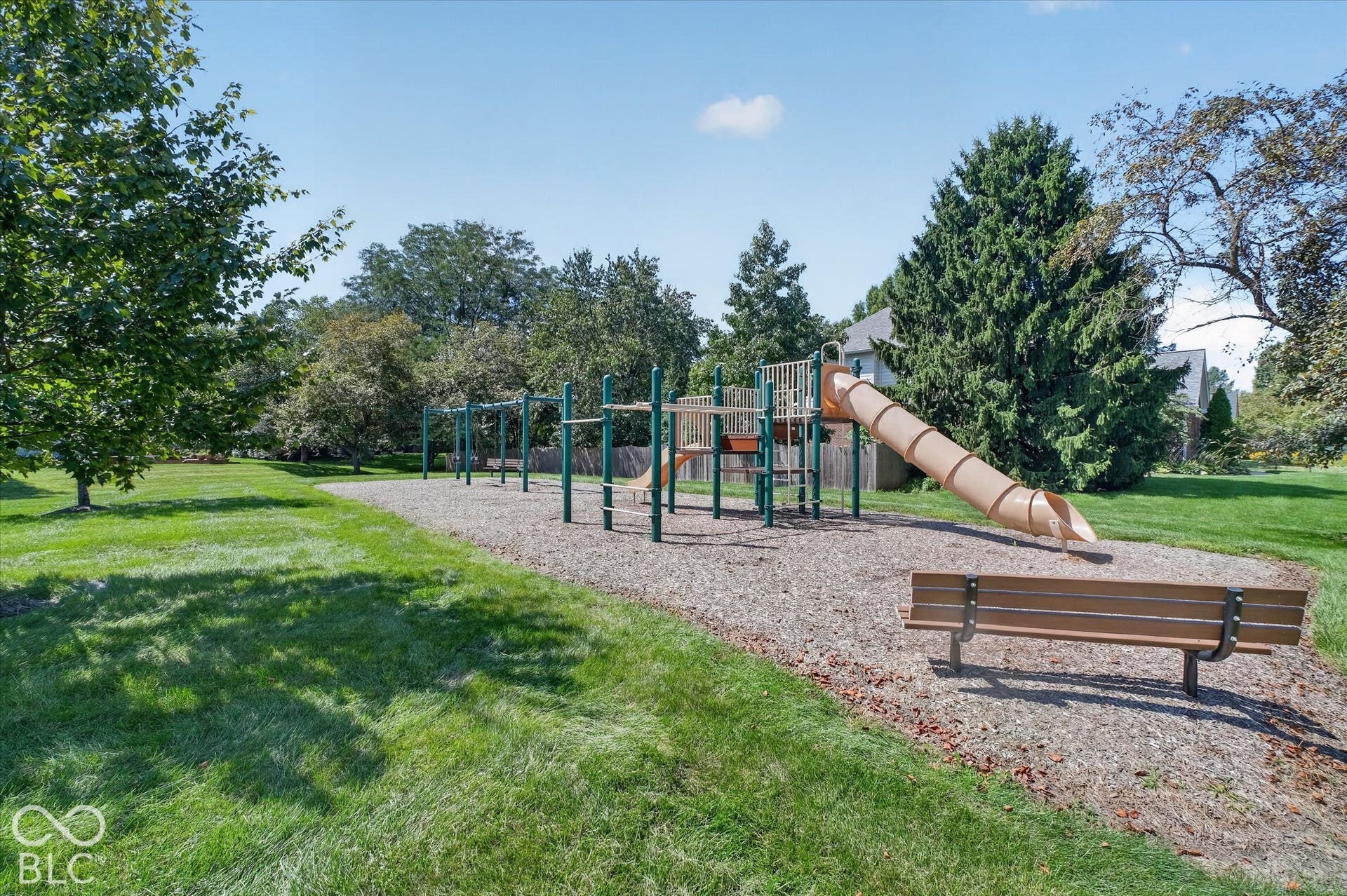 Recreational playground structure featuring a tube slide, monkey bars, and a climbing platform