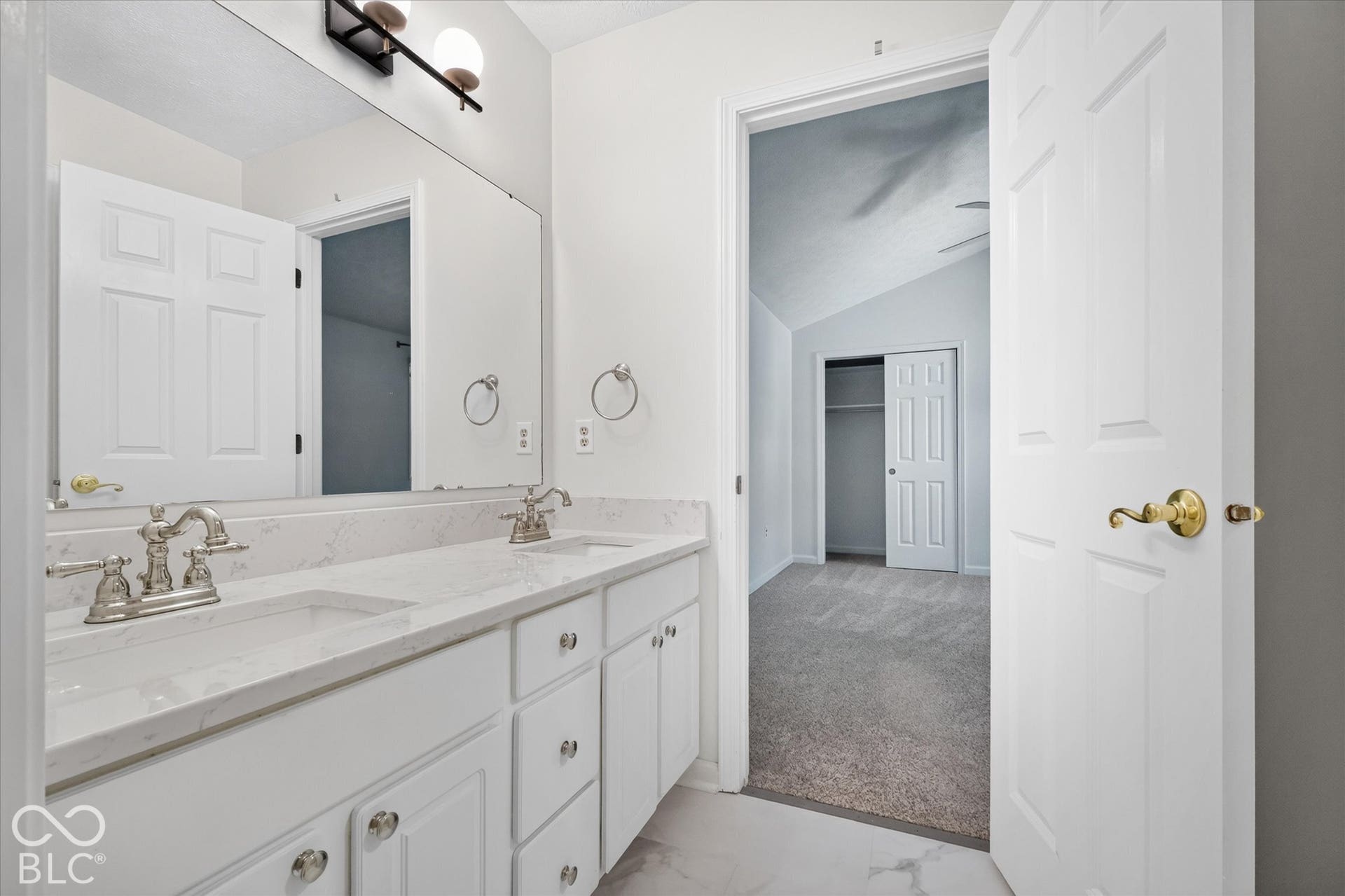 Dual vanity with undermount sinks, brushed nickel faucets, and a full-width mirror
