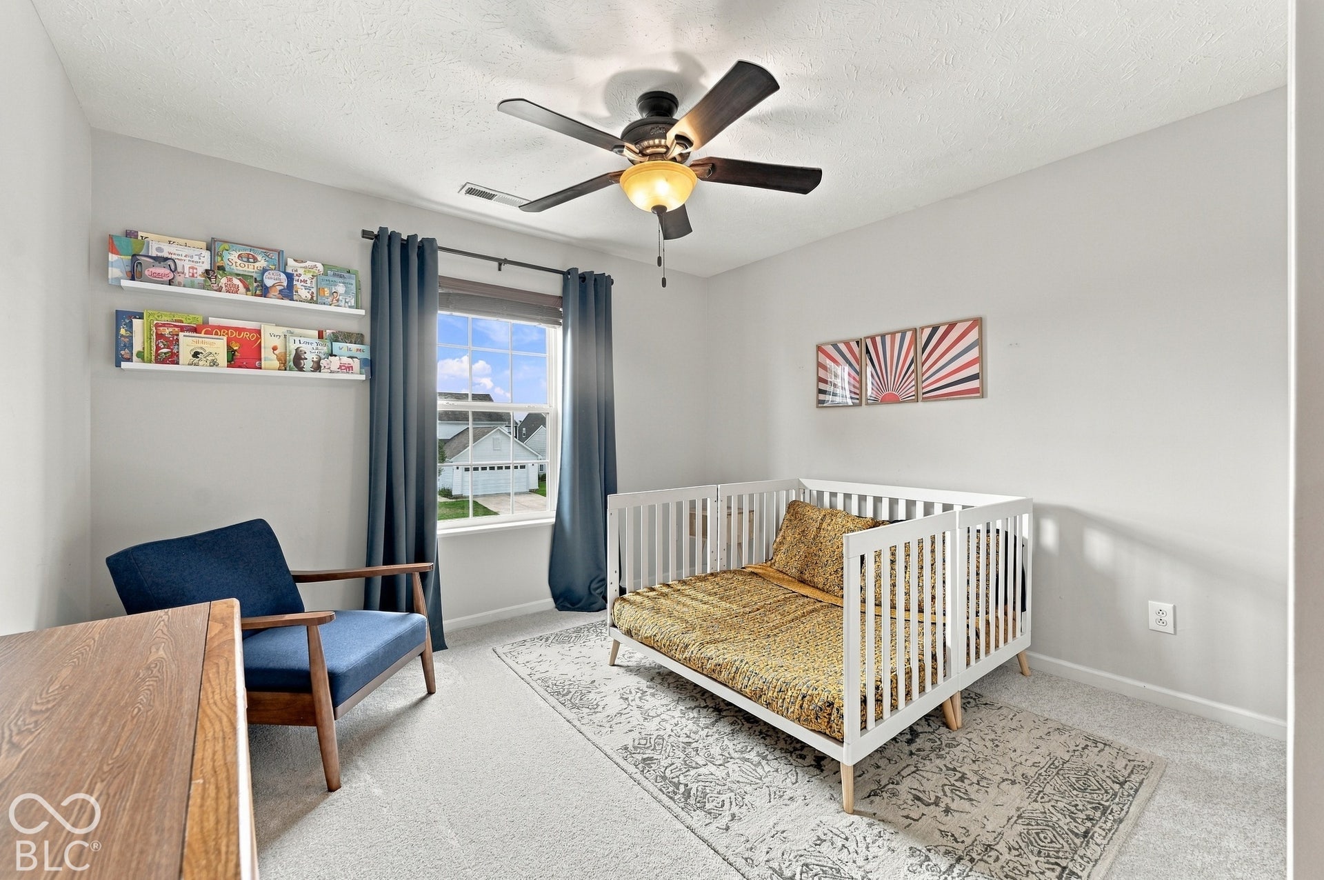 Light gray painted walls, a ceiling fan with integrated lighting, and carpeted flooring