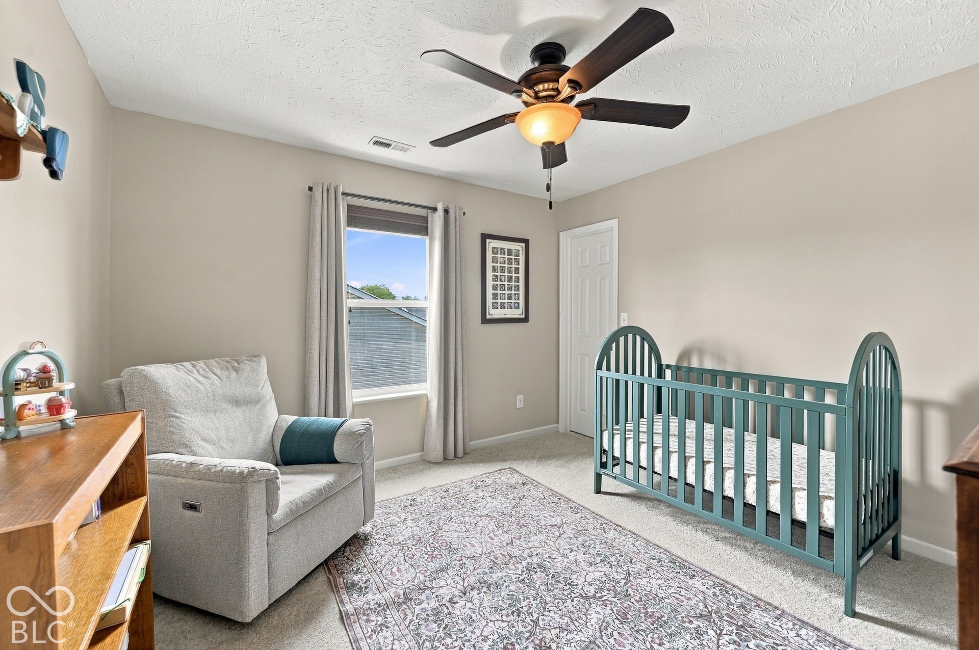 Neutral-toned walls complement the carpeted flooring