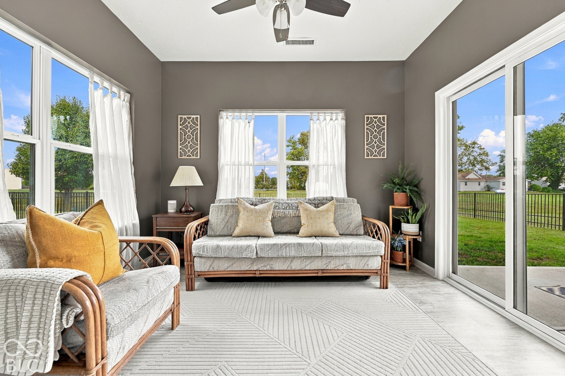 Expansive windows and a sliding glass door provide natural light