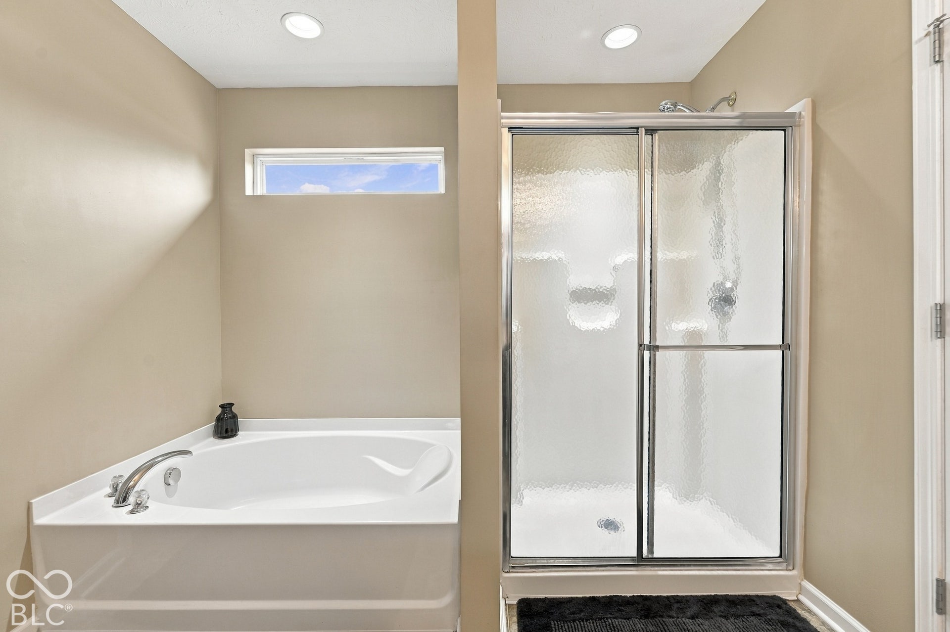 Soaking tub with deck-mounted chrome fixtures