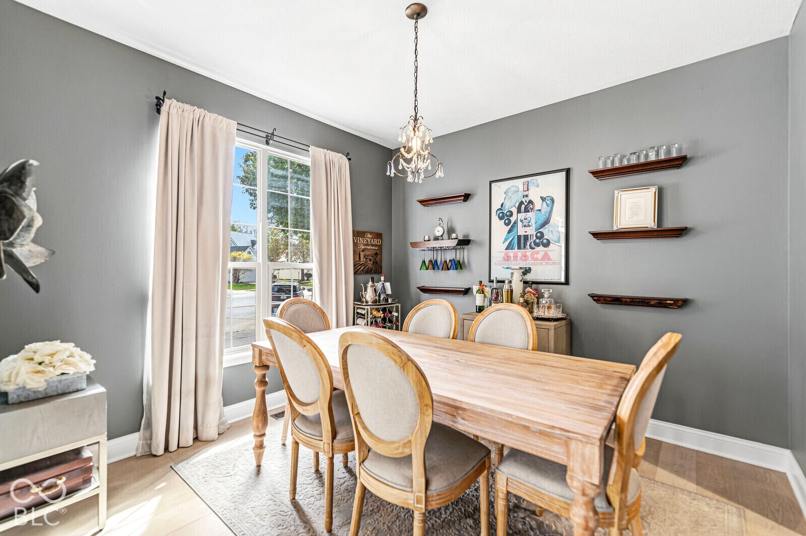 Recessed lighting, wood-finish flooring, and a decorative chandelier