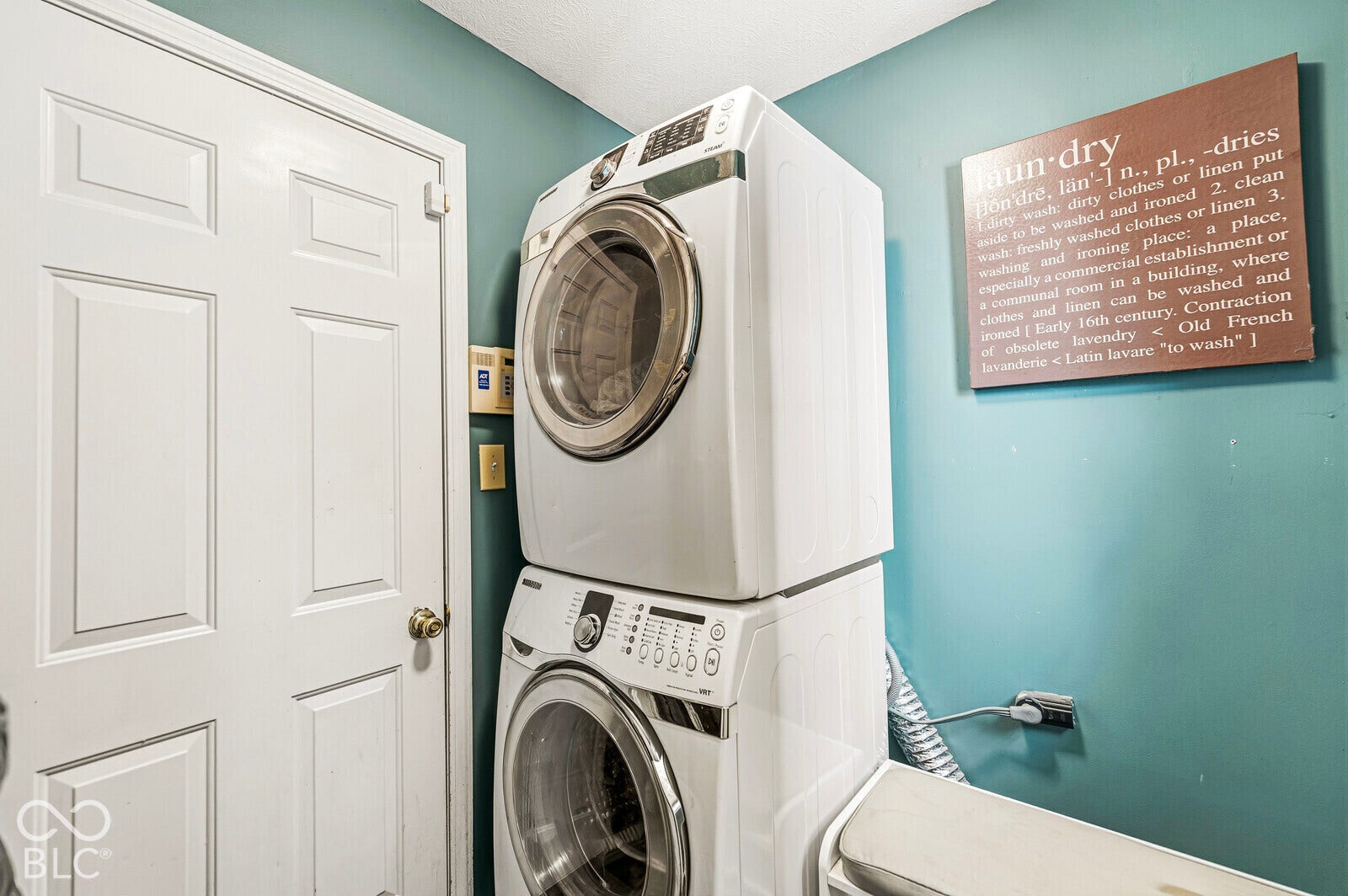 Stacked front-loading washer and dryer, panel door, and painted wall