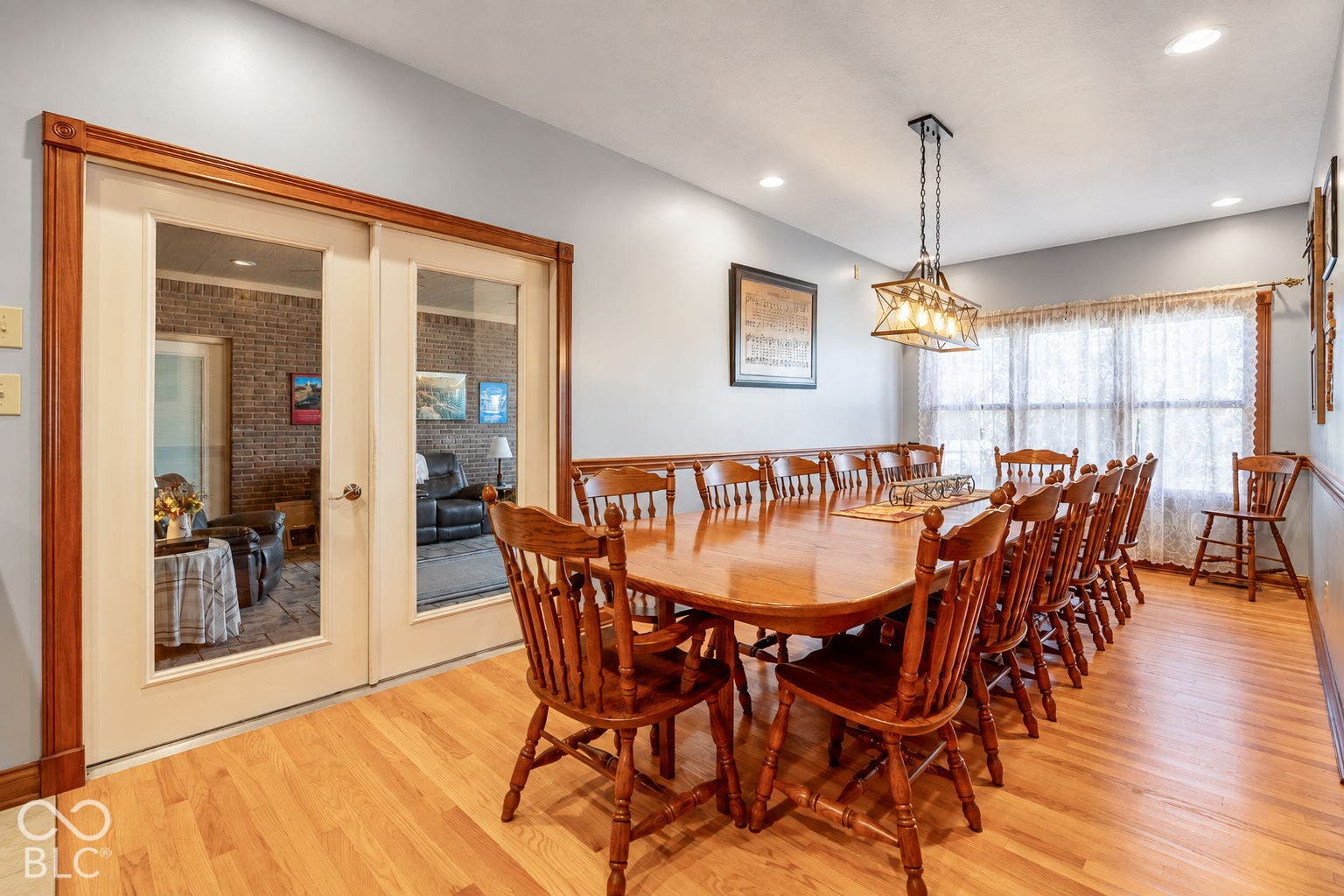 Hardwood flooring throughout, recessed lighting, and a multi-light fixture