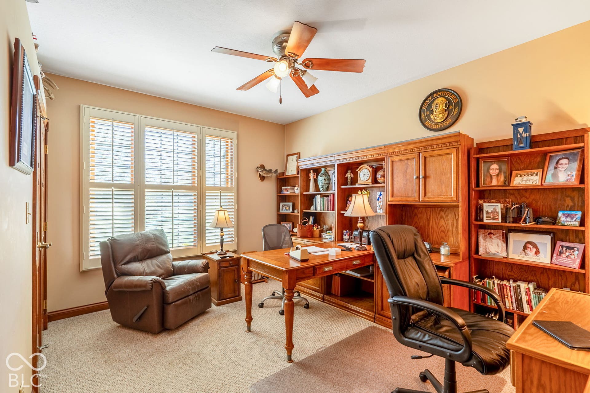 Built-in wood cabinetry, integrated desk, and shelving