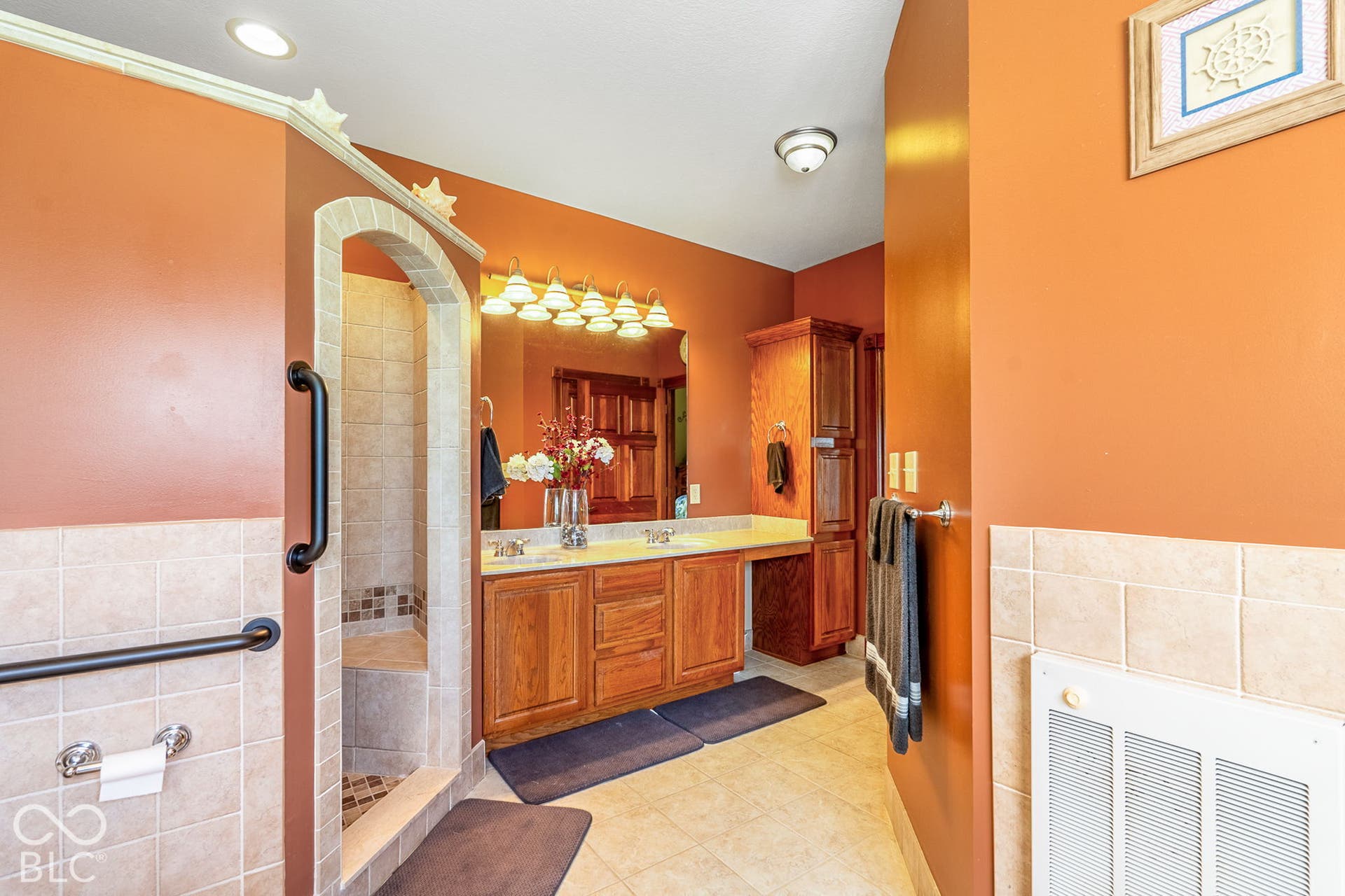 Dual vanity with wood-finish cabinetry and light-toned countertops