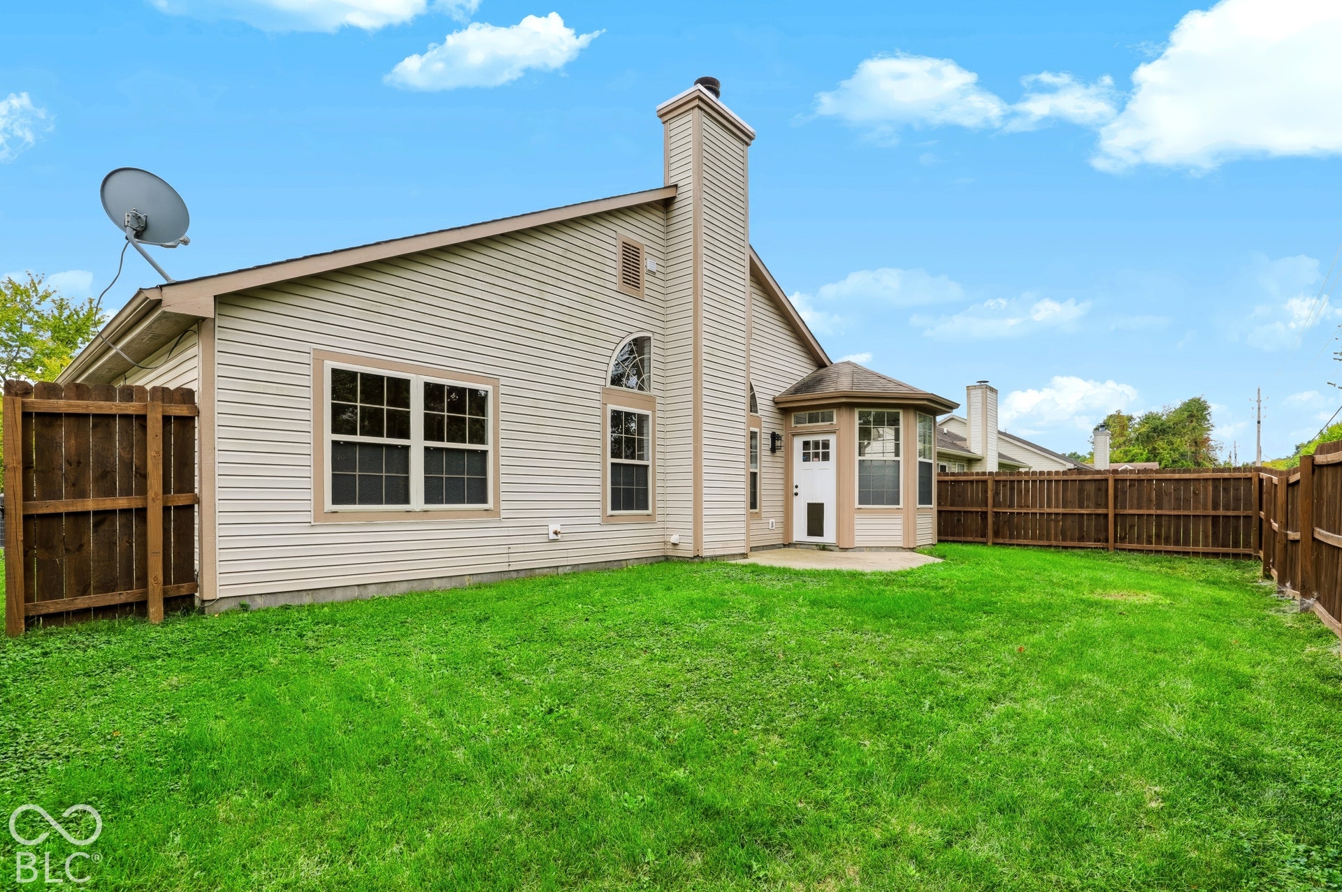 Expansive lawn area with a full privacy fence