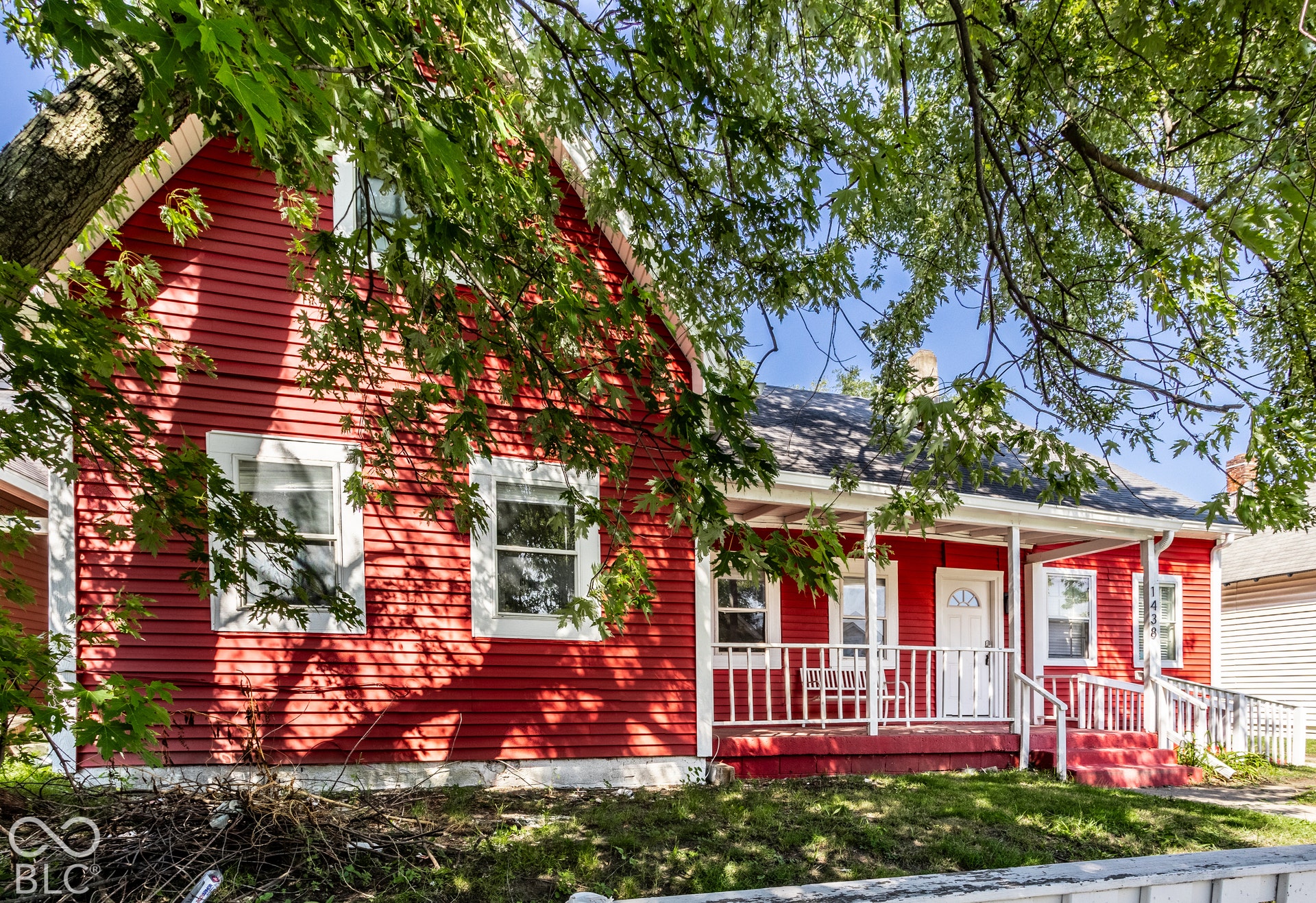 Red siding exterior with white trim windows