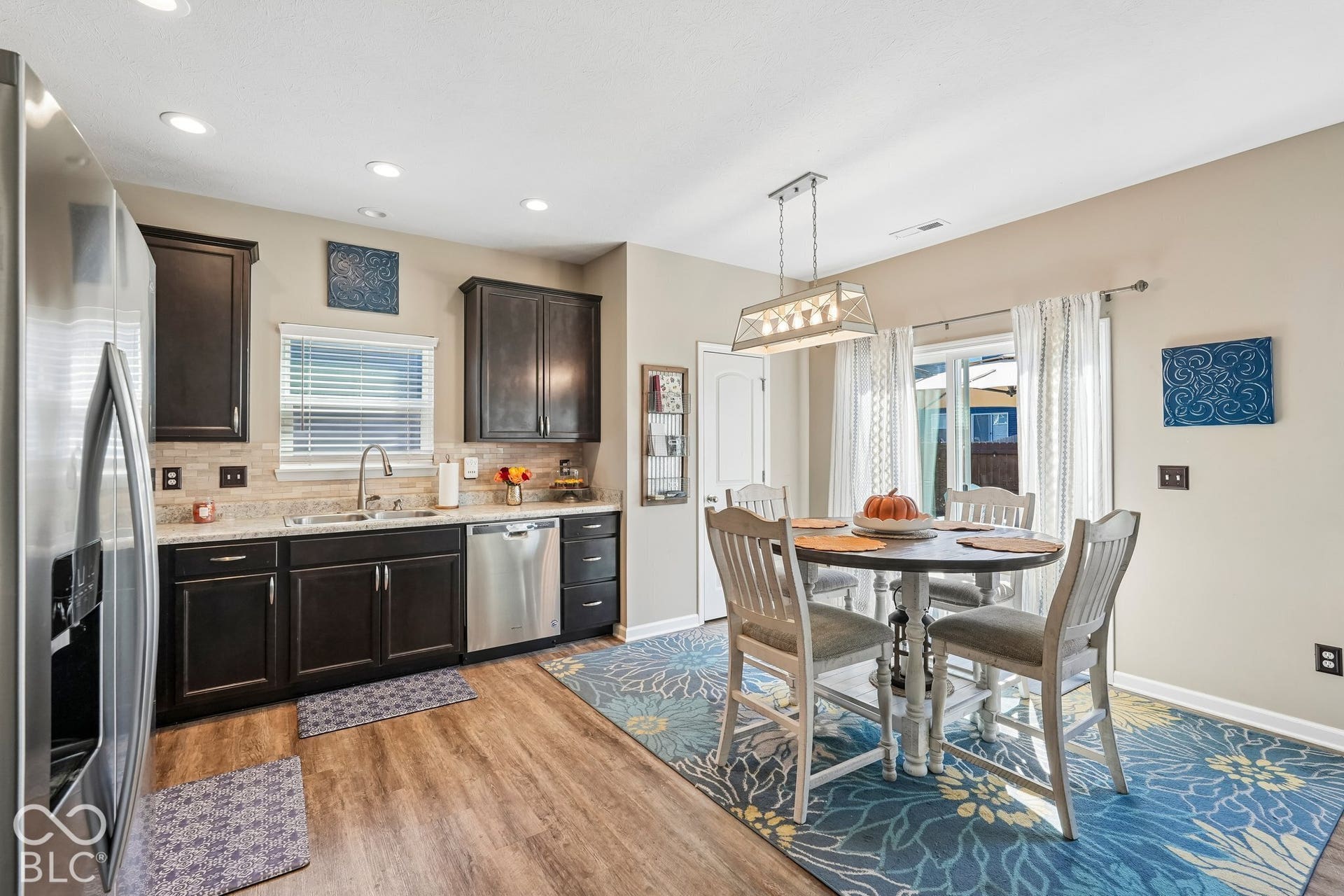 2945 W Calimanco Lane, Monrovia, IN 46157 Kitchen featuring dark wood cabinetry, stainless steel appliances, light-toned backsplash, granite countertops, and wood-finish flooring